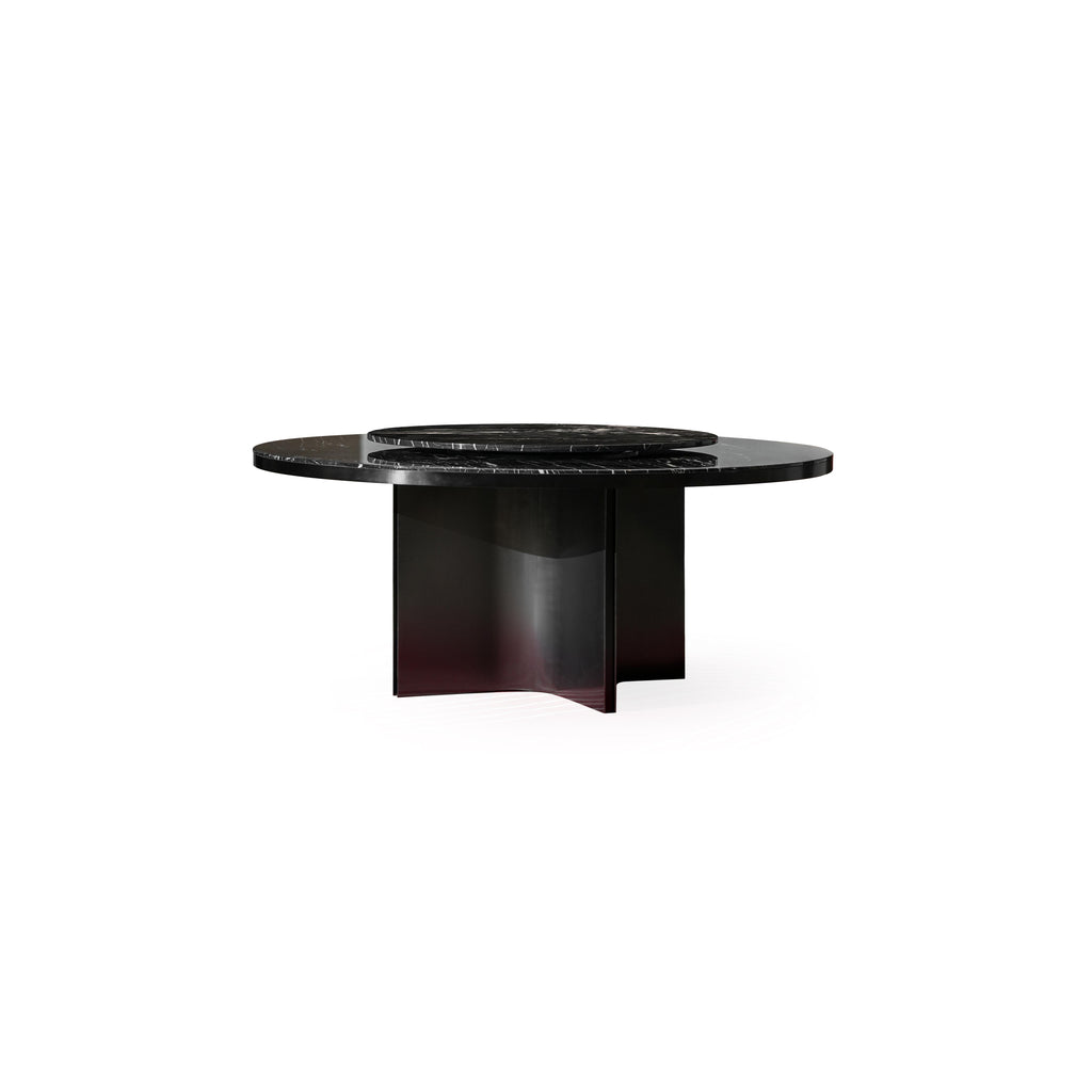 Round dining table with dark gray marble top and matte black metal base featuring three curved legs. Smooth, polished surface with natural veining. Structurally supported by central pillar and side supports. Intended for dining or serving. Category: furniture/dining-tables