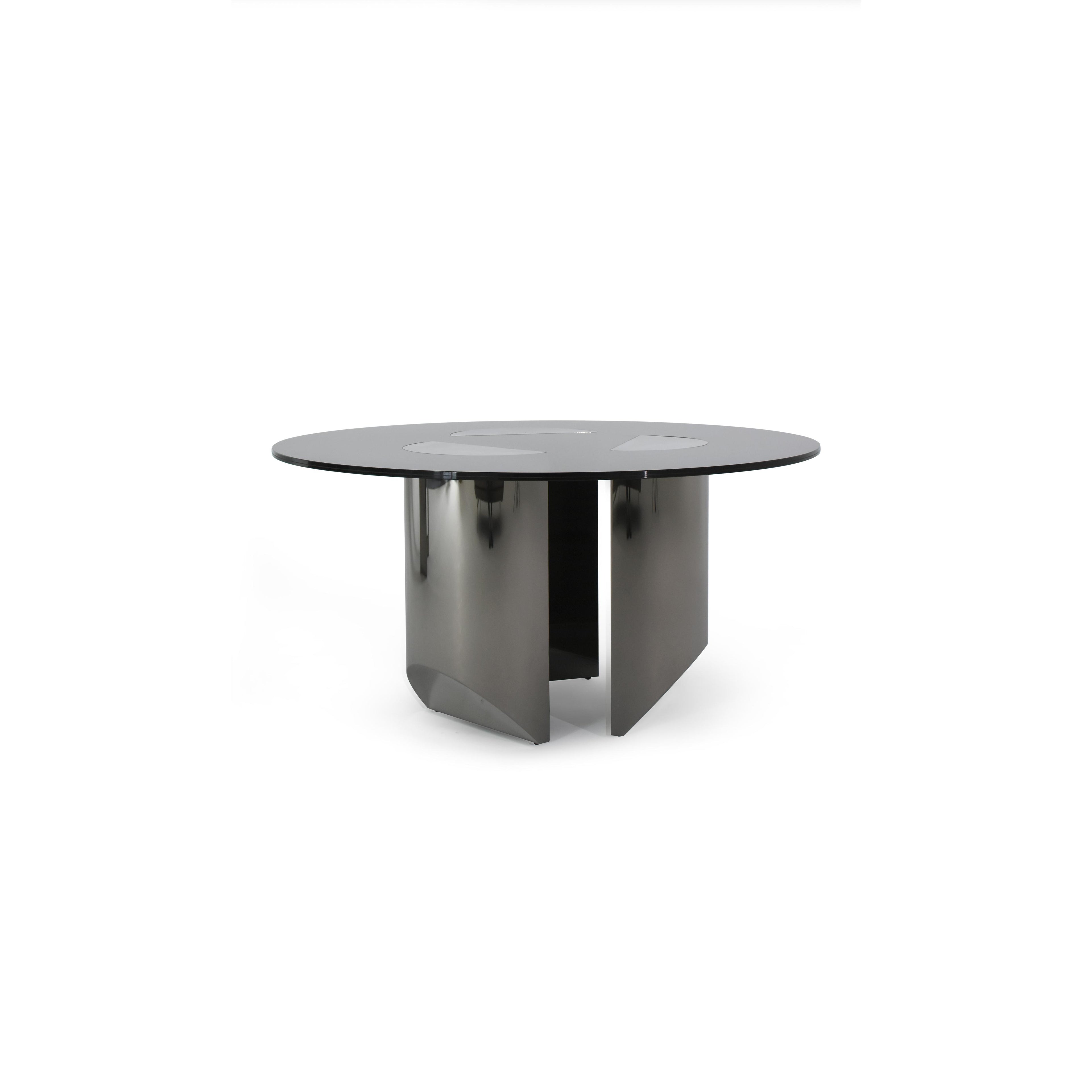 Round dining table with black glass top and dark metallic base featuring four angular legs. Table has three circular cutouts on the surface. Intended for dining or seating. Category: furniture/dining-tables