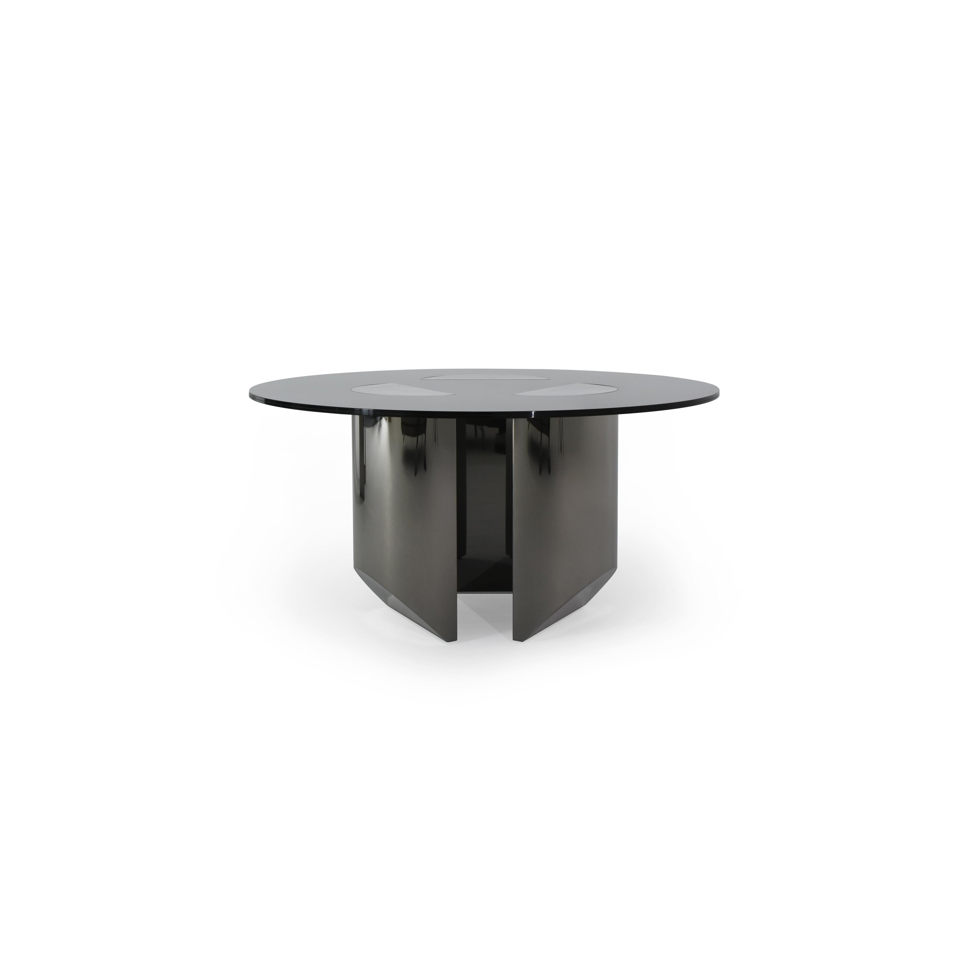 Round dining table with black glass top and dark metallic base featuring four angular legs. Table has three circular cutouts on the surface. Intended for dining or seating. Category: furniture/dining-tables
