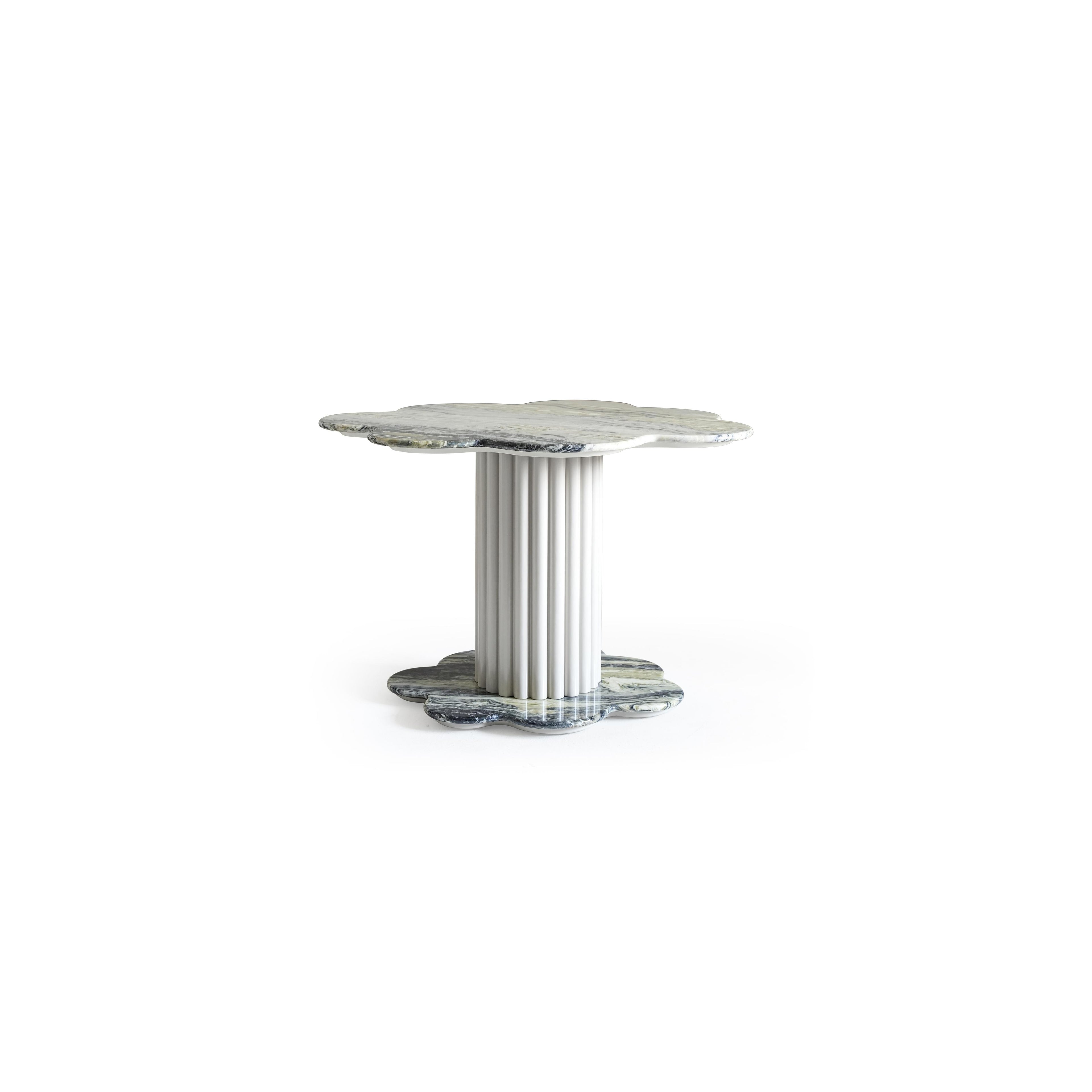 A small side table with a scalloped, marbled top and matching base, supported by a fluted central column. The surface and base show natural veining in gray and white tones. Intended for placing items beside seating. Category: furniture/tables/side-tables