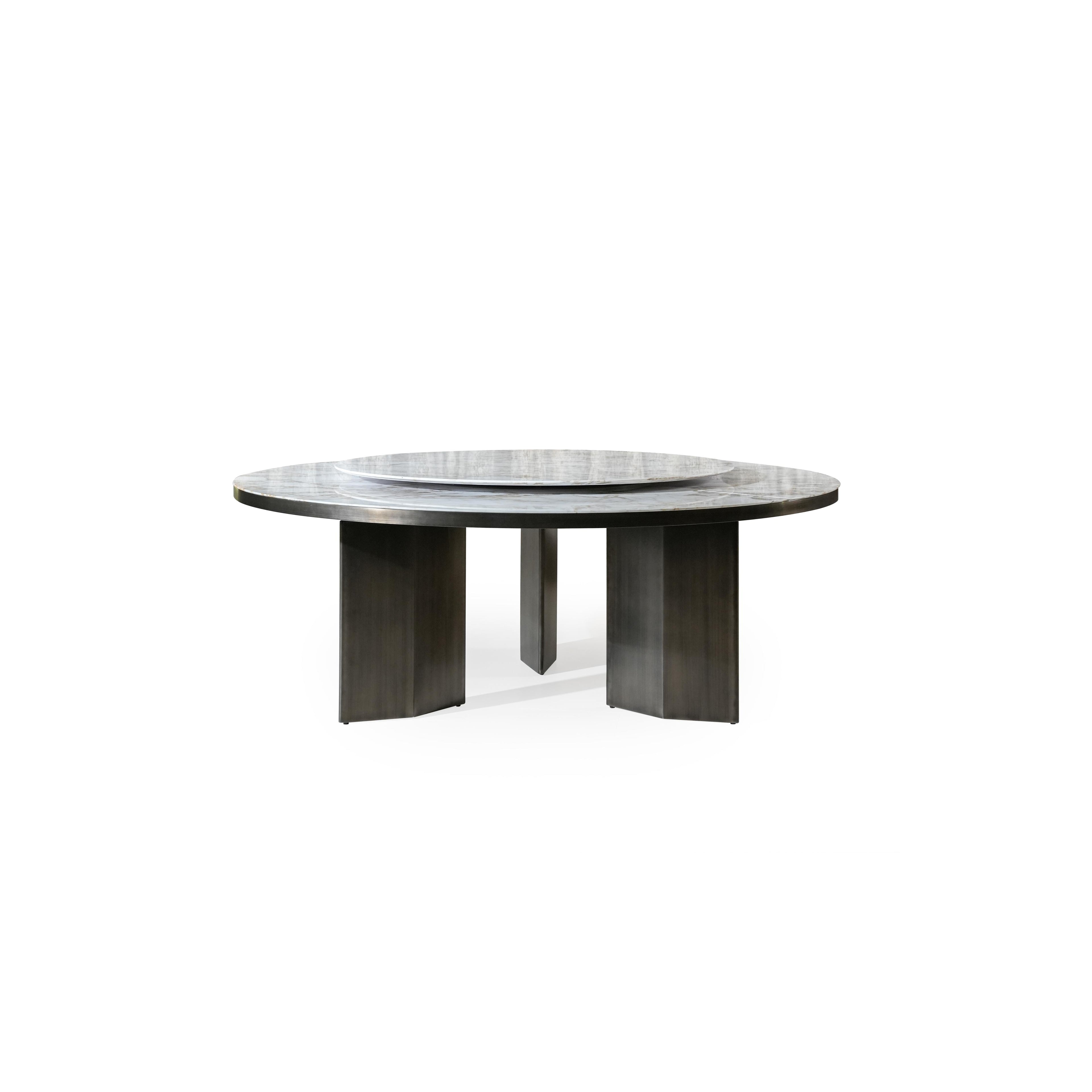 Round dining table with a marble top and dark metal legs, featuring a central rotating tray. The table has three thick, rectangular legs supporting a flat, circular surface. Category: furniture/dining-tables
