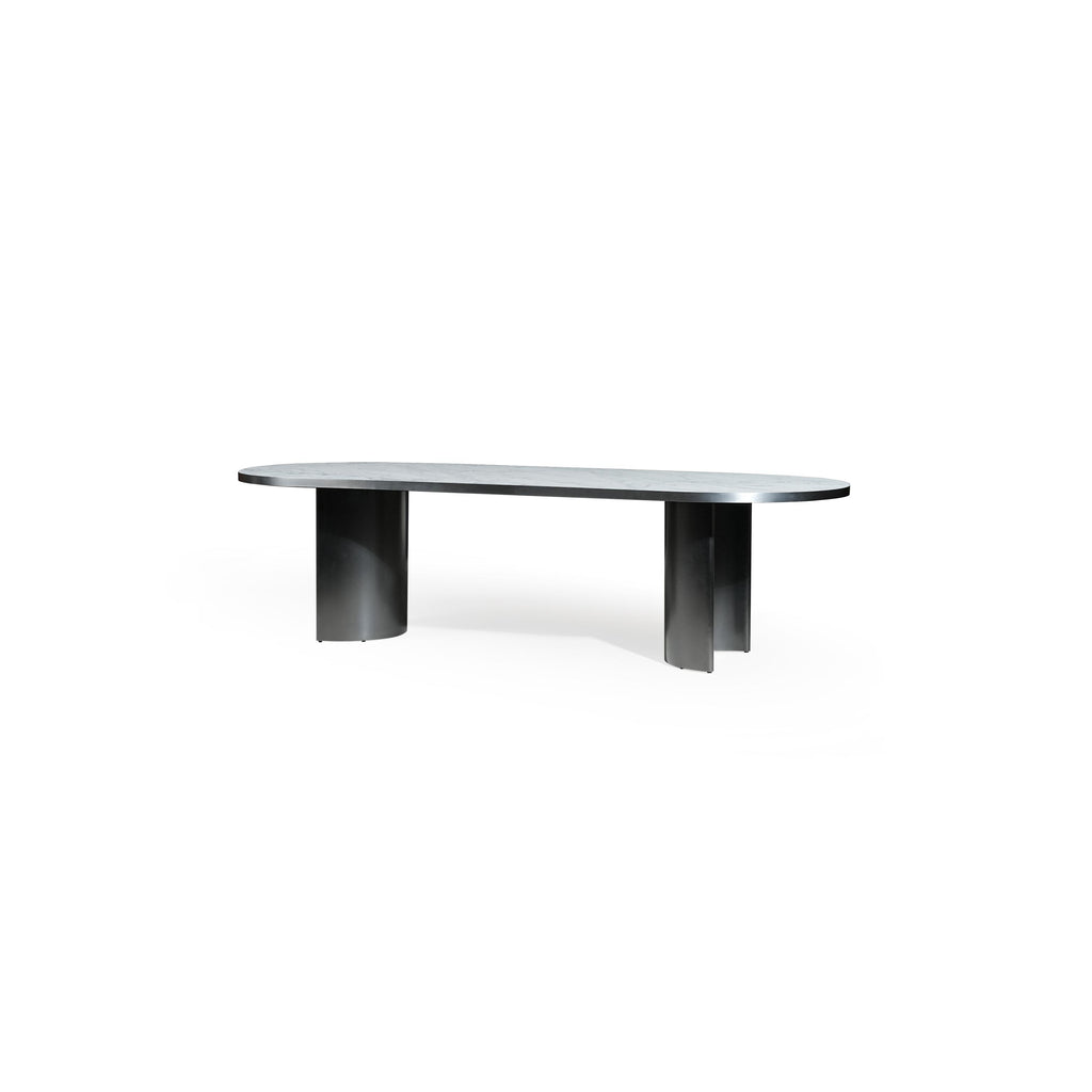 Modern oval dining table with a smooth, light gray stone top and two cylindrical black metal legs. Sleek, minimalist design supports flat surface for dining or work. Category: furniture/dining-tables