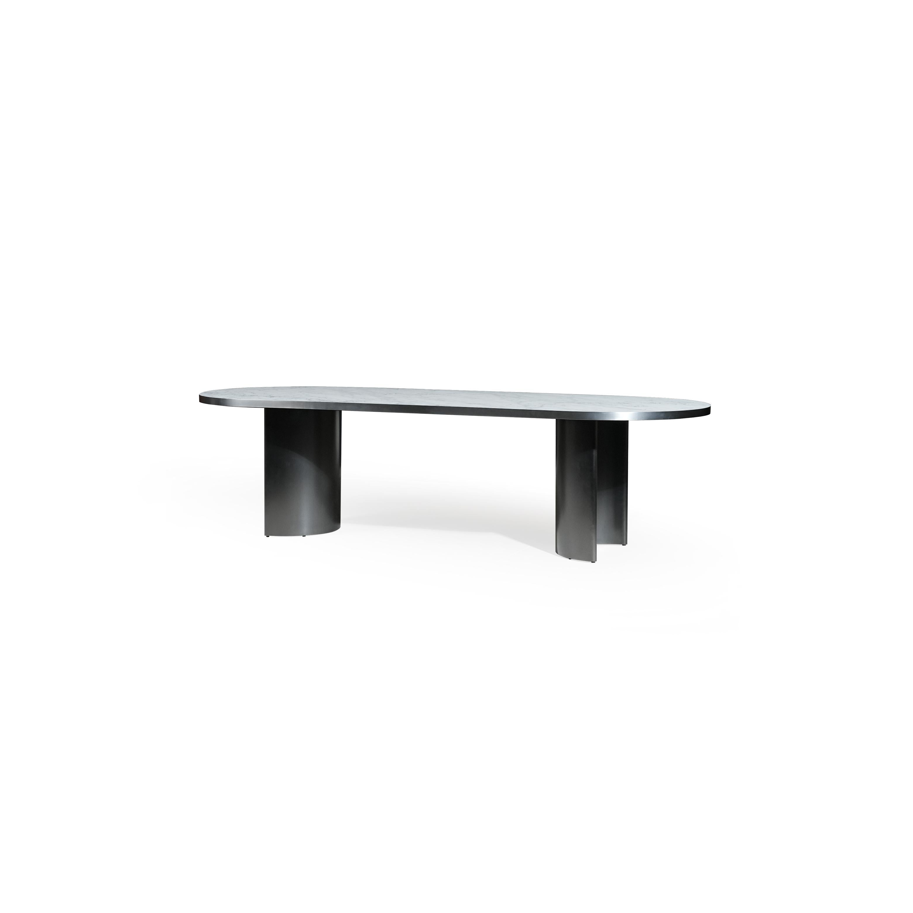 Modern oval dining table with a smooth, light gray stone top and two cylindrical black metal legs. Sleek, minimalist design supports flat surface for dining or work. Category: furniture/dining-tables
