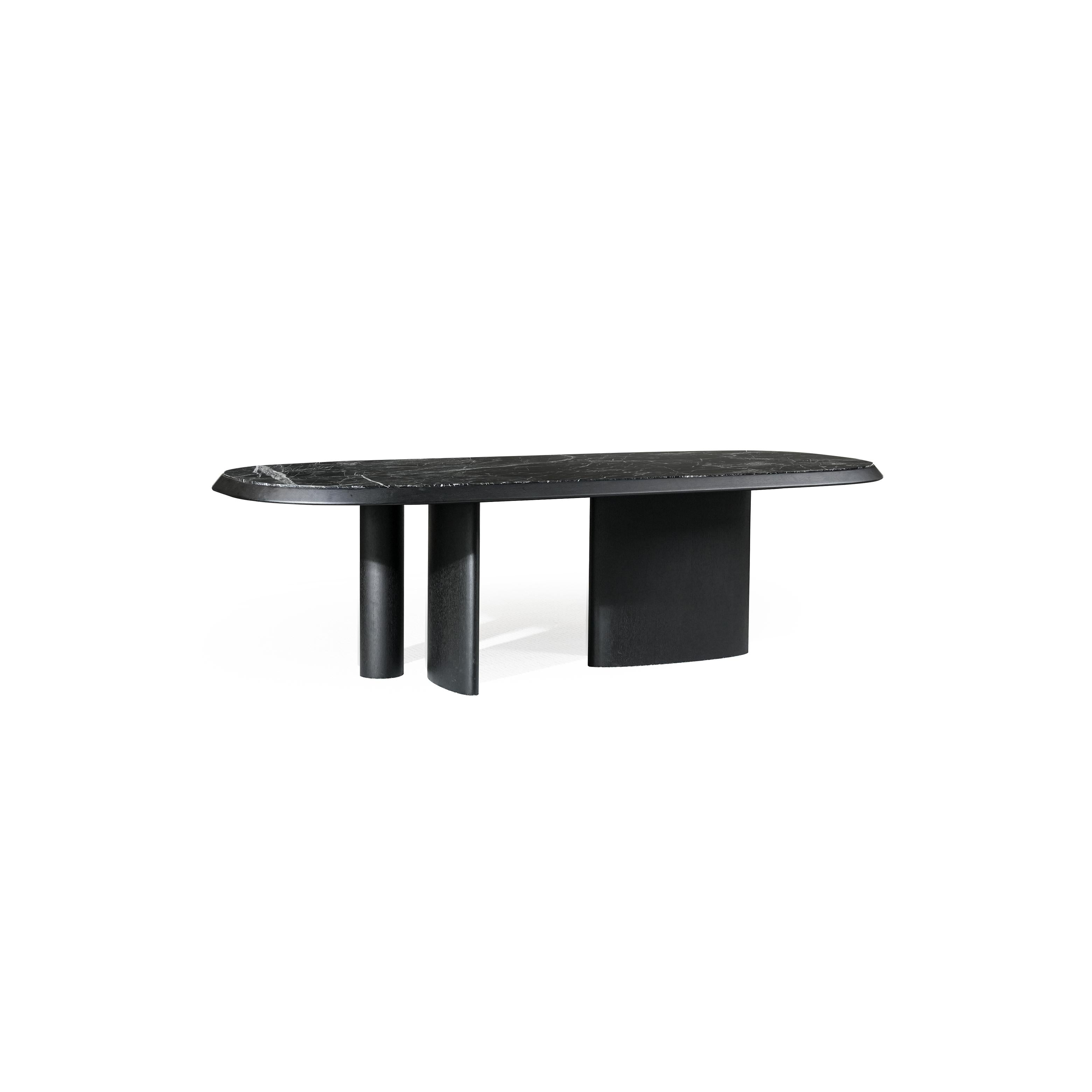 Modern coffee table with oval top and light wood finish, supported by two cylindrical legs and a central pedestal base; top surface has subtle wood grain texture; designed for placing items on a living room or lounge area; distinctively shaped with rounded edges and minimalistic structure. Category: furniture/coffee-tables