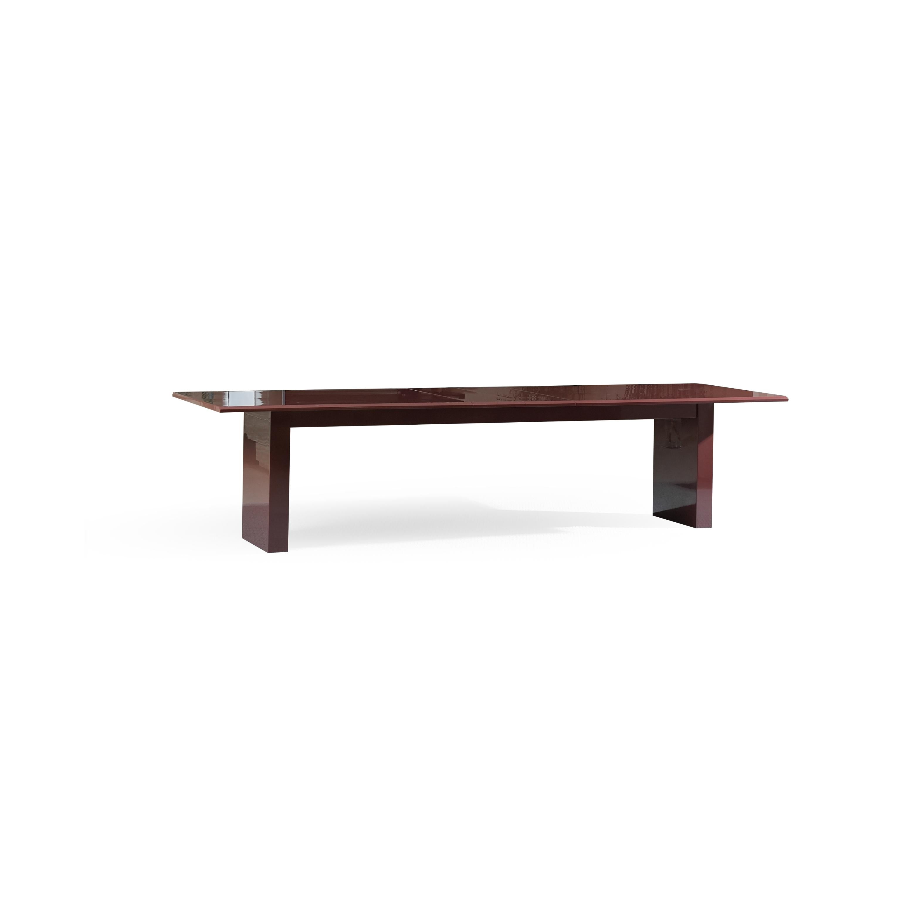 A rectangular dining table with a glossy dark reddish-brown surface and matching legs, featuring a central seam suggesting extendable functionality, supported by two vertical rectangular legs with a slight taper, intended for seating and dining, Category: Furniture > Dining Tables > Extendable Dining Tables.