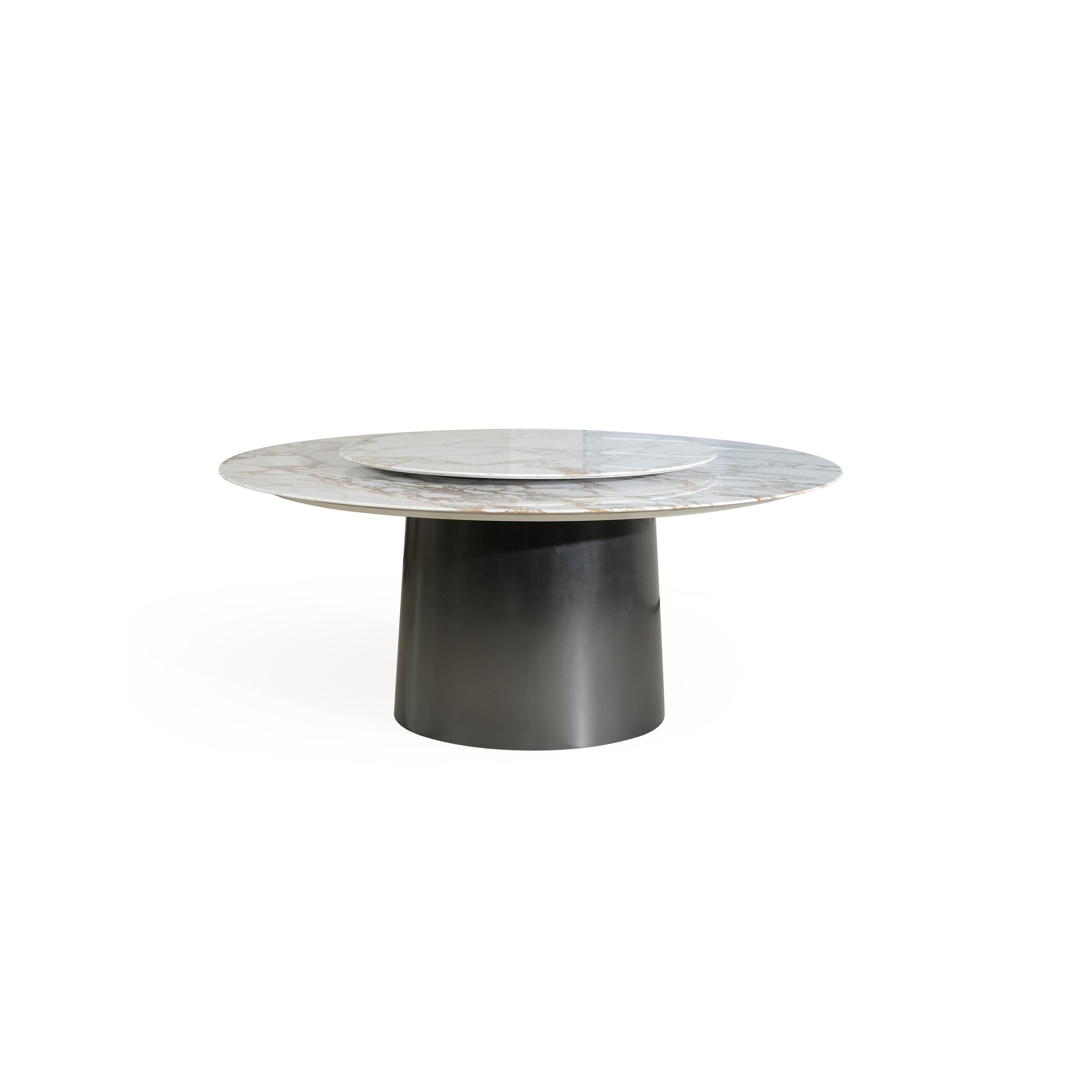 Round dining table with a marble top featuring light gray base and golden veining, supported by a cylindrical dark metal pedestal base. The table has a concentric circular design with a smaller circular inset on the surface. Intended for dining or serving. Category: furniture/dining-tables
