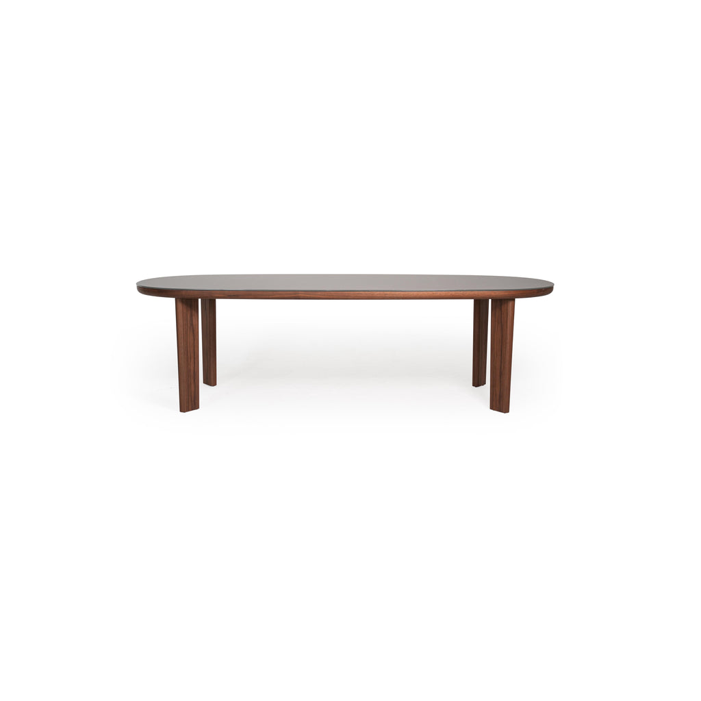 Oval dining table with dark wood legs and a smooth, matte gray tabletop. Four straight legs support the elongated surface. Wood grain visible on legs. Intended for dining or seating. Category: furniture/dining-tables