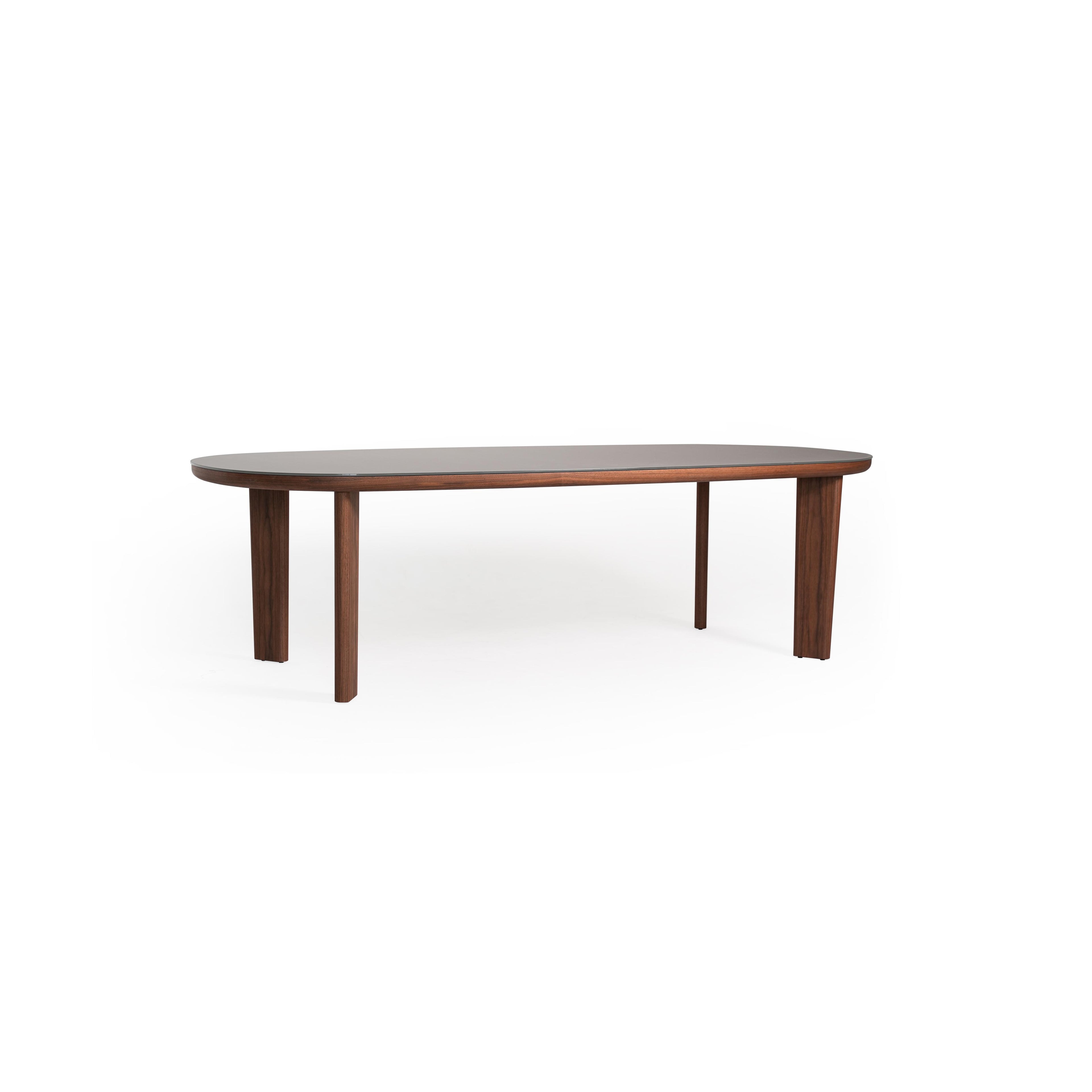 Oval dining table with dark wood legs and a smooth, matte gray tabletop. Four straight legs support the elongated surface. Wood grain visible on legs. Intended for dining or seating. Category: furniture/dining-tables