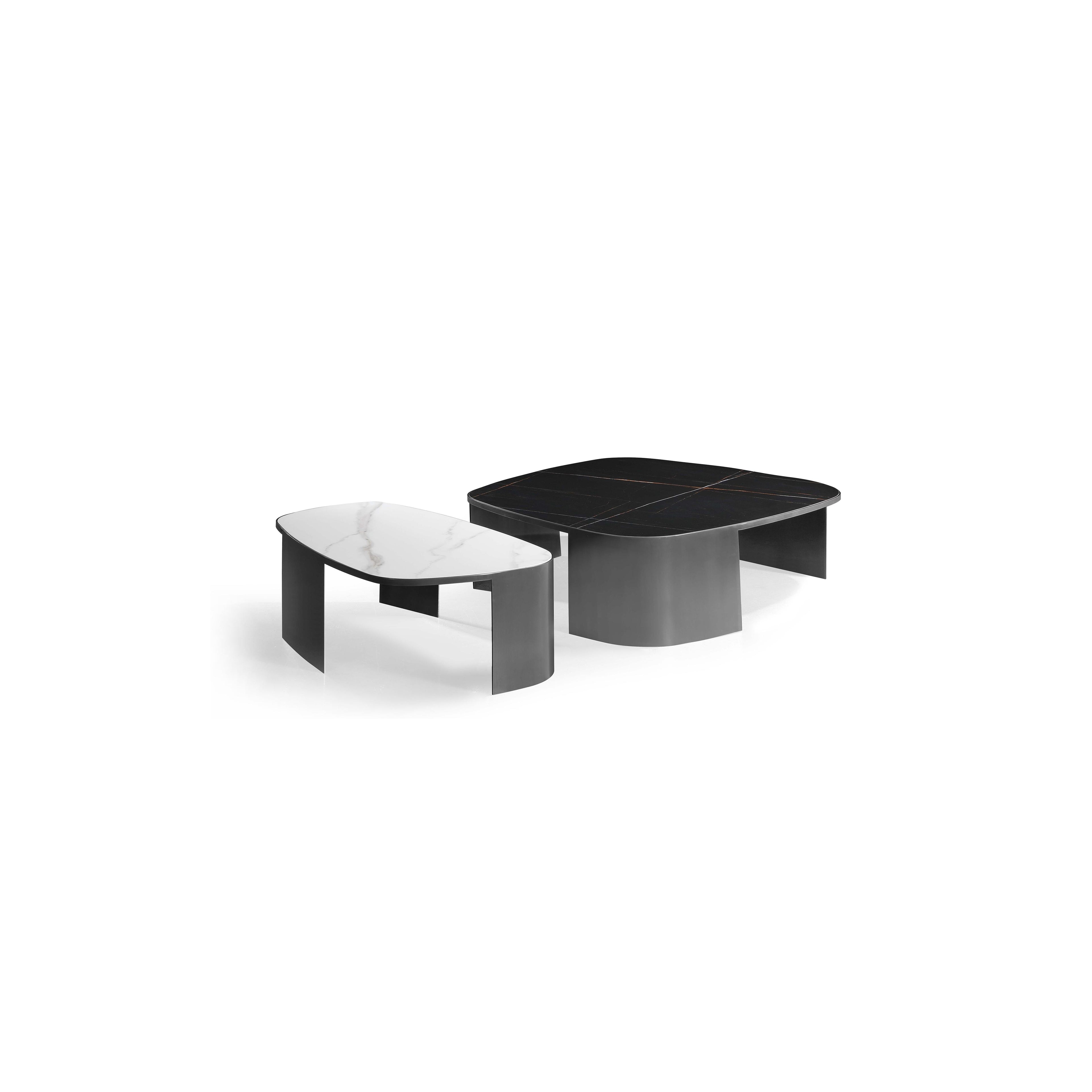 Modern coffee table with a white marble top and a black marble top, both resting on curved, dark metal legs. The table has a low profile and asymmetrical shape. Intended for placing drinks or small items. Category: furniture/coffee-tables