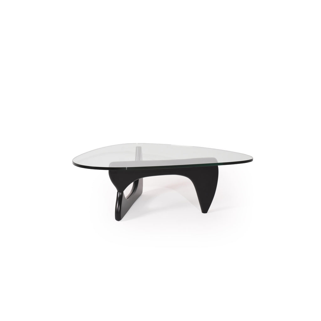 Modern coffee table with a transparent glass top and a black, sculpted base featuring two curved legs and a central support. Designed for placing items on a surface, it has no visible handles, drawers, or upholstery. Category: furniture/coffee-tables