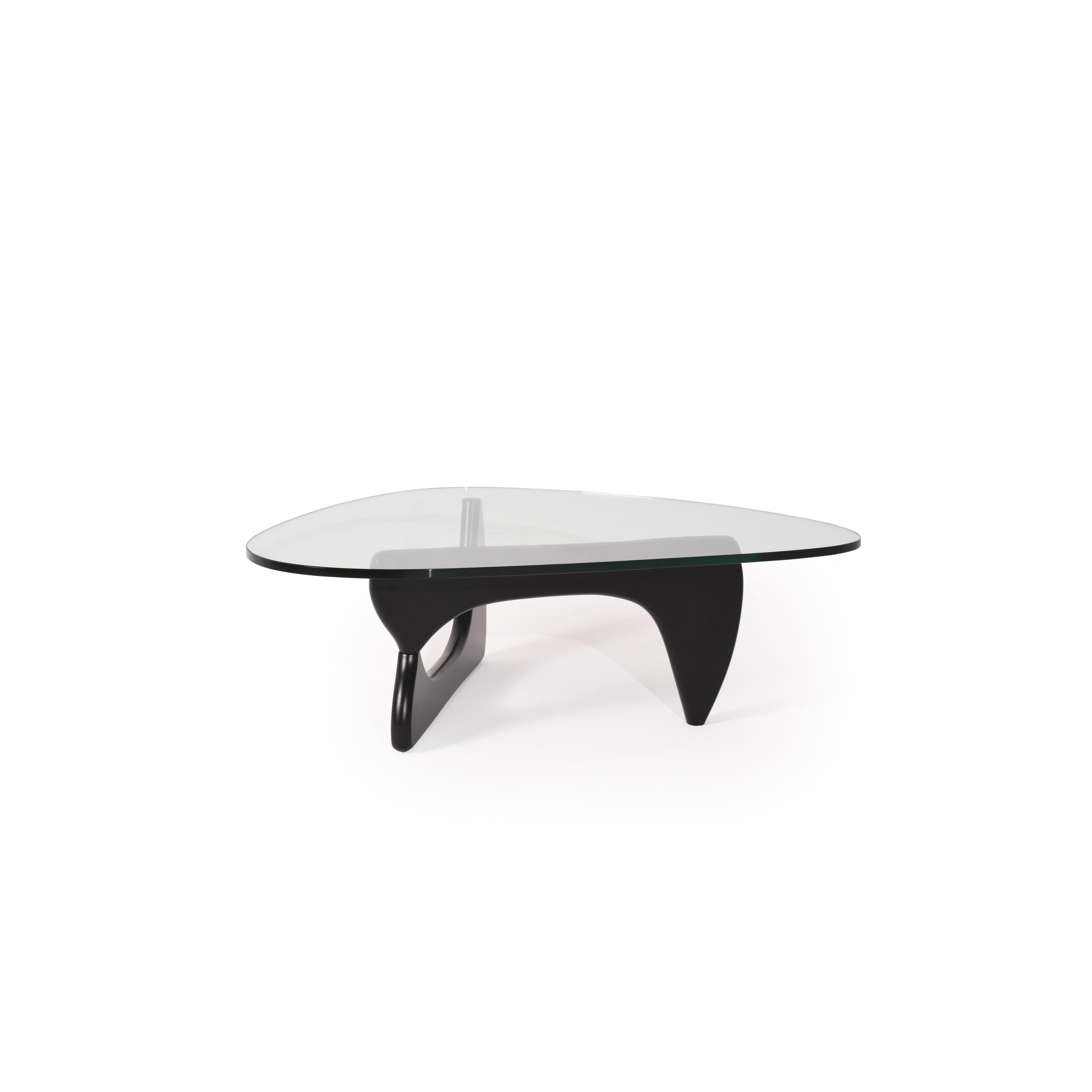 Modern coffee table with a transparent glass top and a black, sculpted base featuring two curved legs and a central support. Designed for placing items on a surface, it has no visible handles, drawers, or upholstery. Category: furniture/coffee-tables