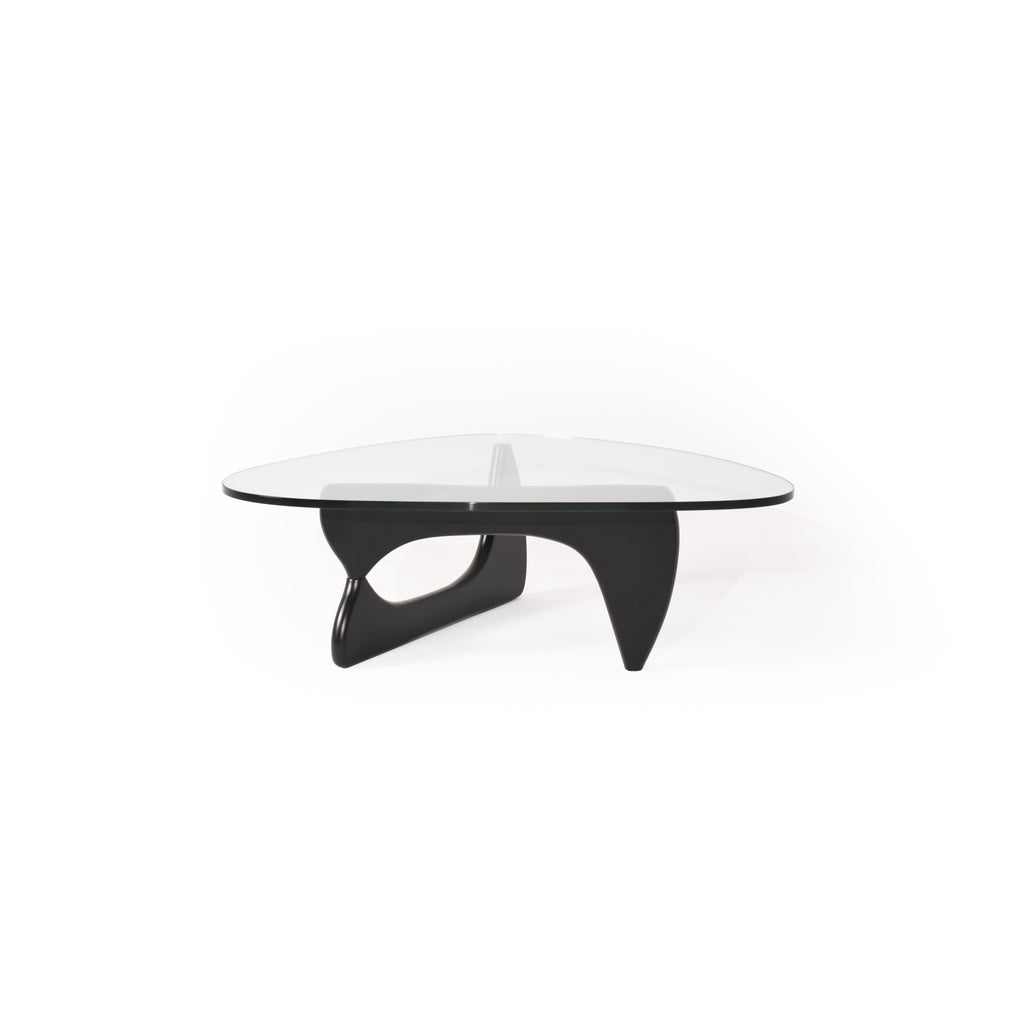 Modern coffee table with a transparent glass top and a black, sculpted base featuring two curved legs and a central support. Designed for placing items on a surface, it has no visible handles, drawers, or upholstery. Category: furniture/coffee-tables