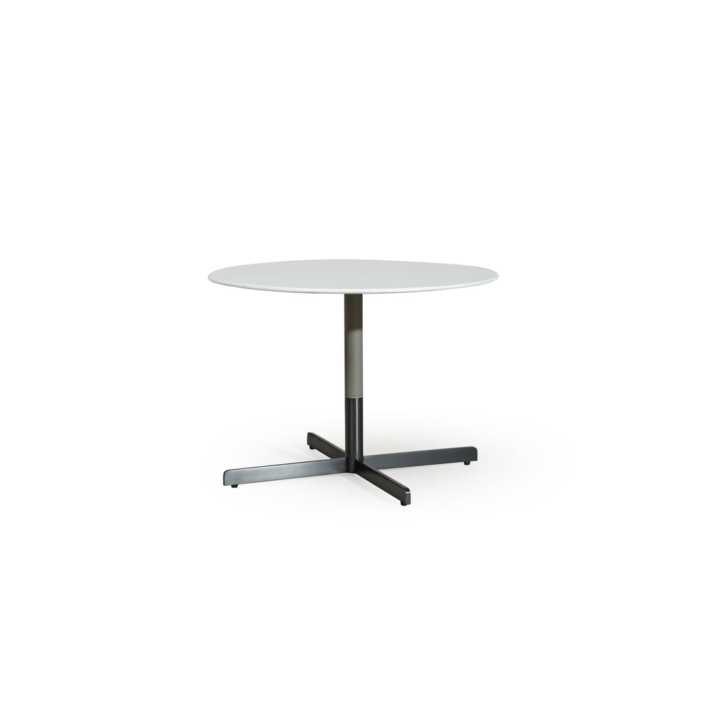 Round table with white top and dark metal base, featuring a central column and X-shaped cross legs. Minimalist design with smooth surfaces and no visible upholstery or handles. Intended for dining or workspaces. Category: furniture > tables > round tables
