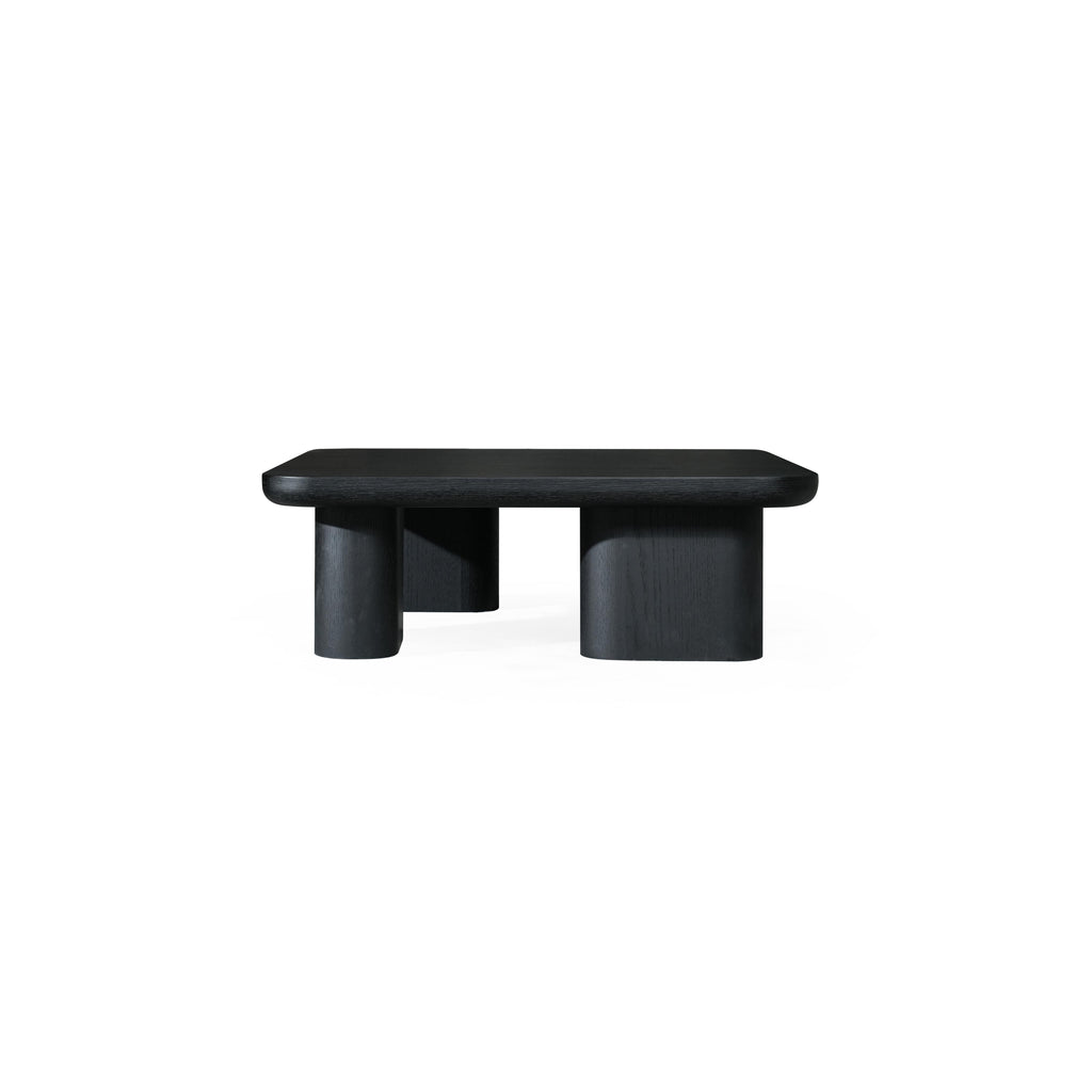 A dark-finished wooden coffee table with a rectangular top and four cylindrical legs, featuring visible wood grain texture and a low-profile, minimalist structure designed for surface placement. Category: Furniture > Coffee Tables