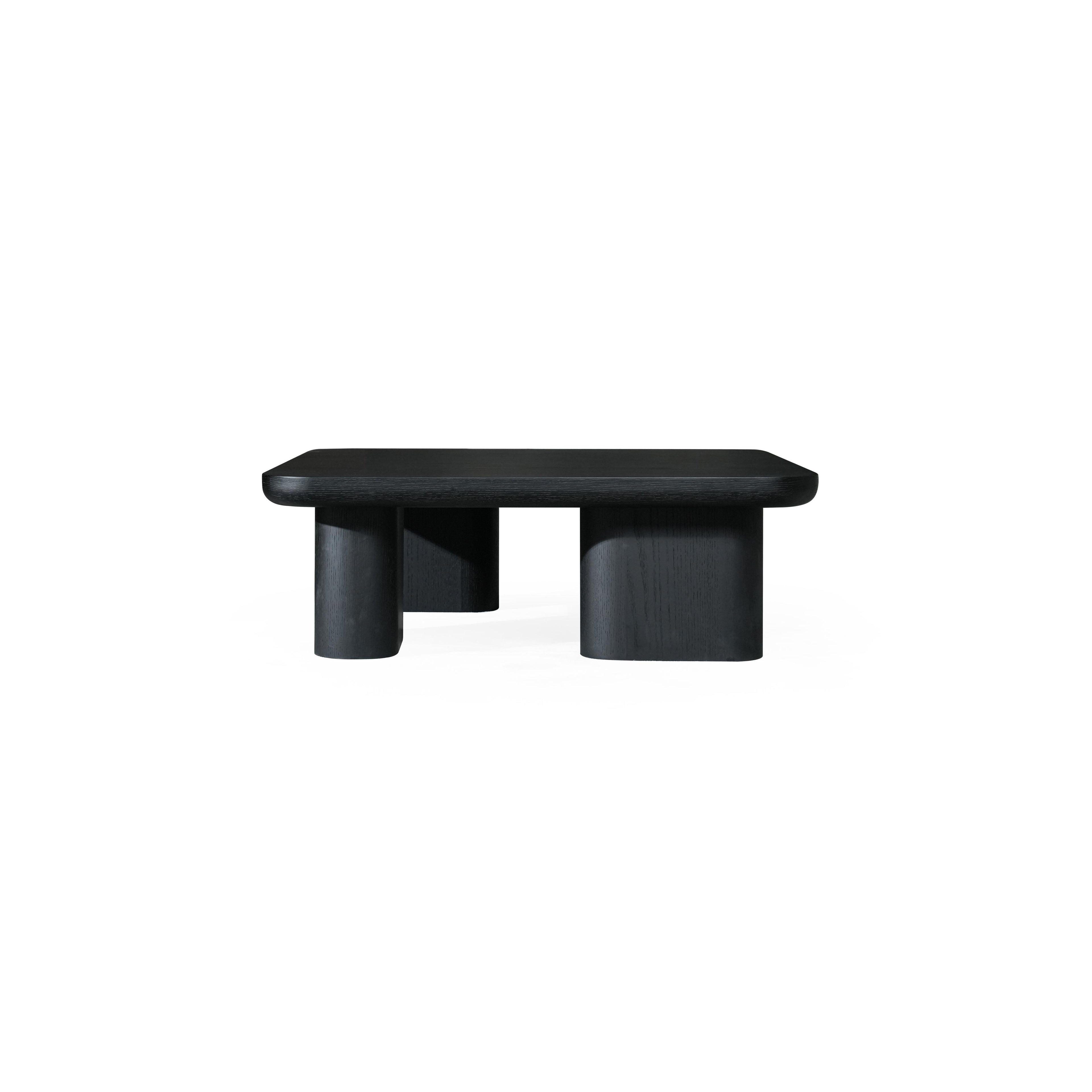 A dark-finished wooden coffee table with a rectangular top and four cylindrical legs, featuring visible wood grain texture and a low-profile, minimalist structure designed for surface placement. Category: Furniture > Coffee Tables
