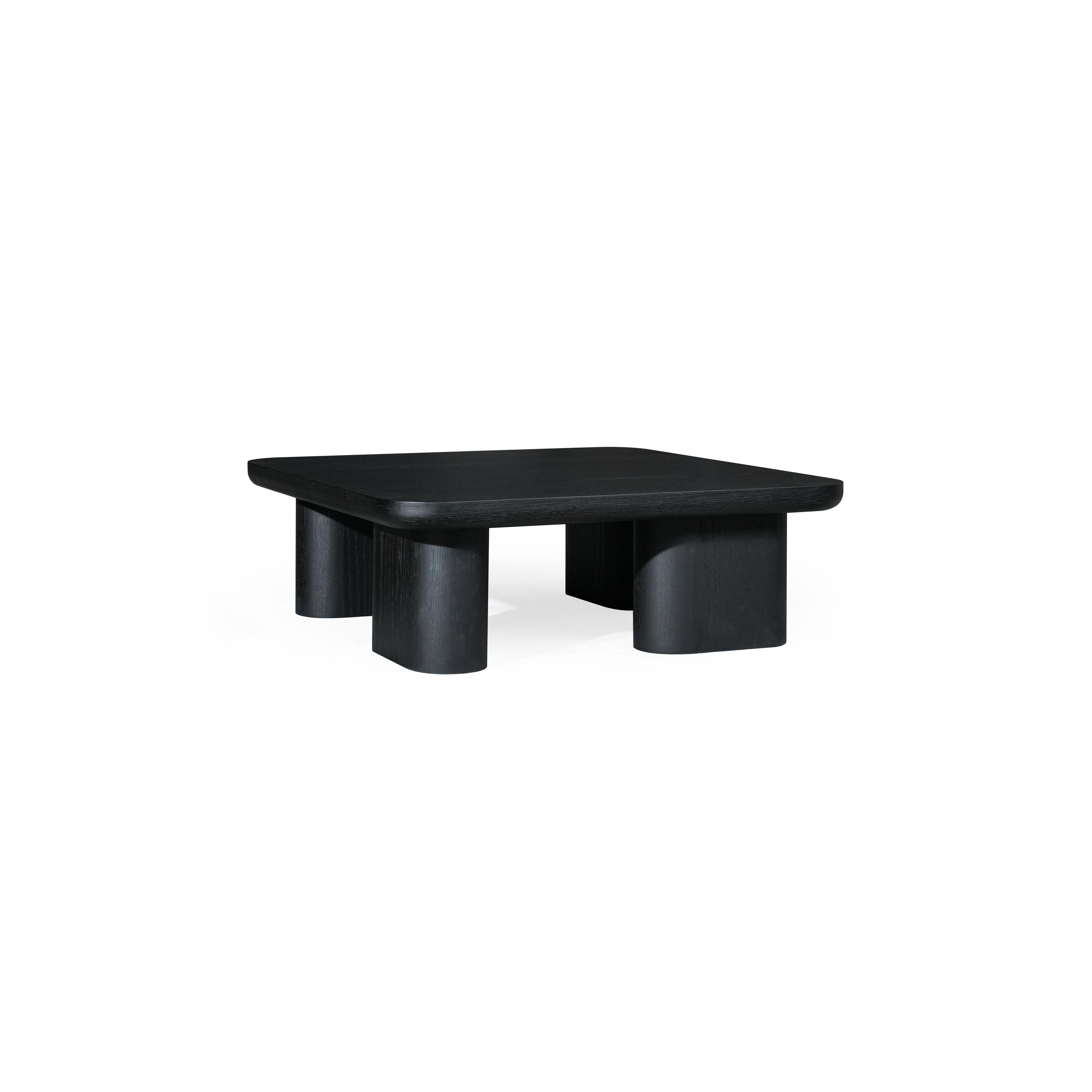 A dark-finished wooden coffee table with a rectangular top and four cylindrical legs, featuring visible wood grain texture and a low-profile, minimalist structure designed for surface placement. Category: Furniture > Coffee Tables