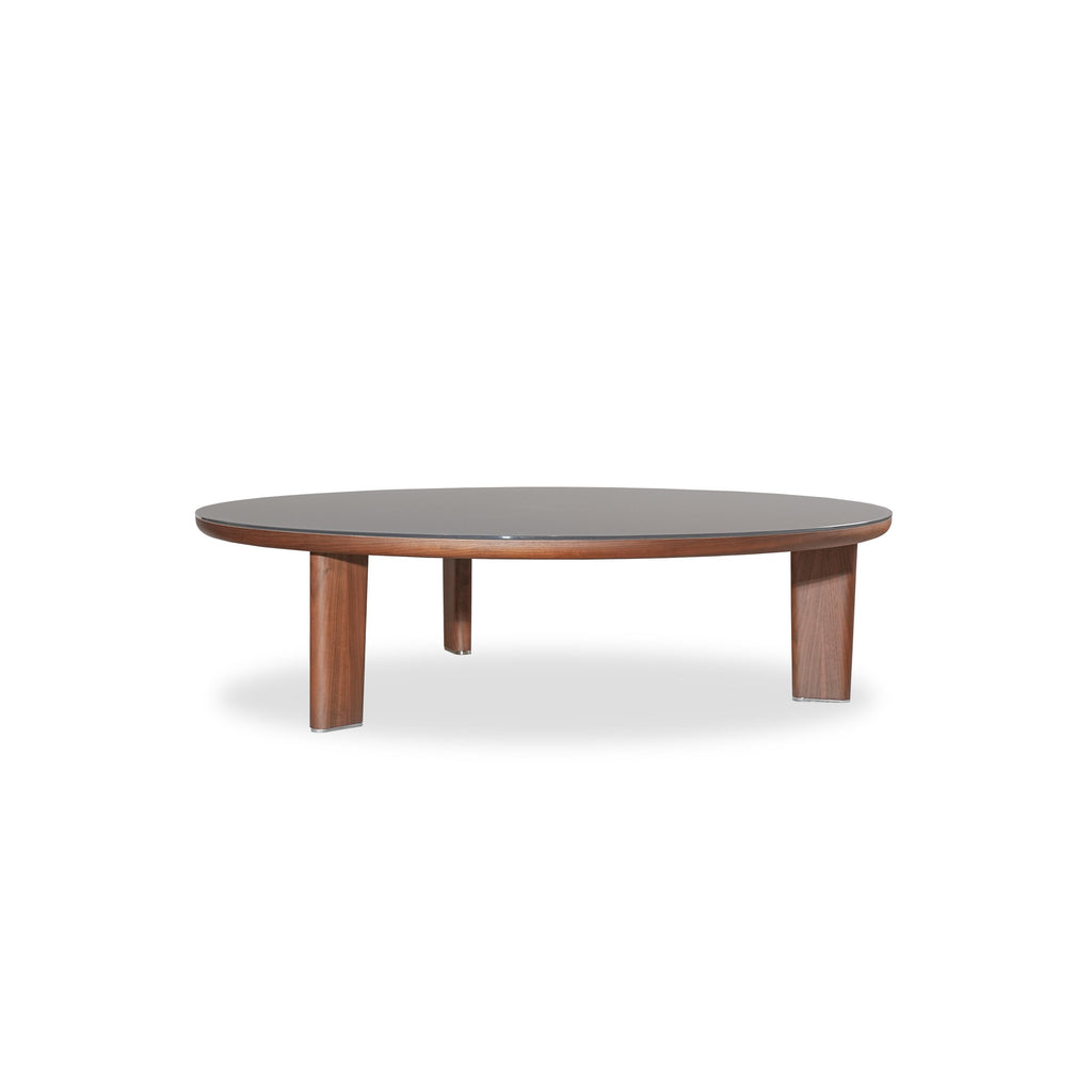 Round coffee table with dark wood legs and a smooth, dark-toned tabletop. Features three sturdy legs supporting a circular surface. Wood grain visible on legs. Intended for placing drinks or small items. Category: furniture/coffee-tables
