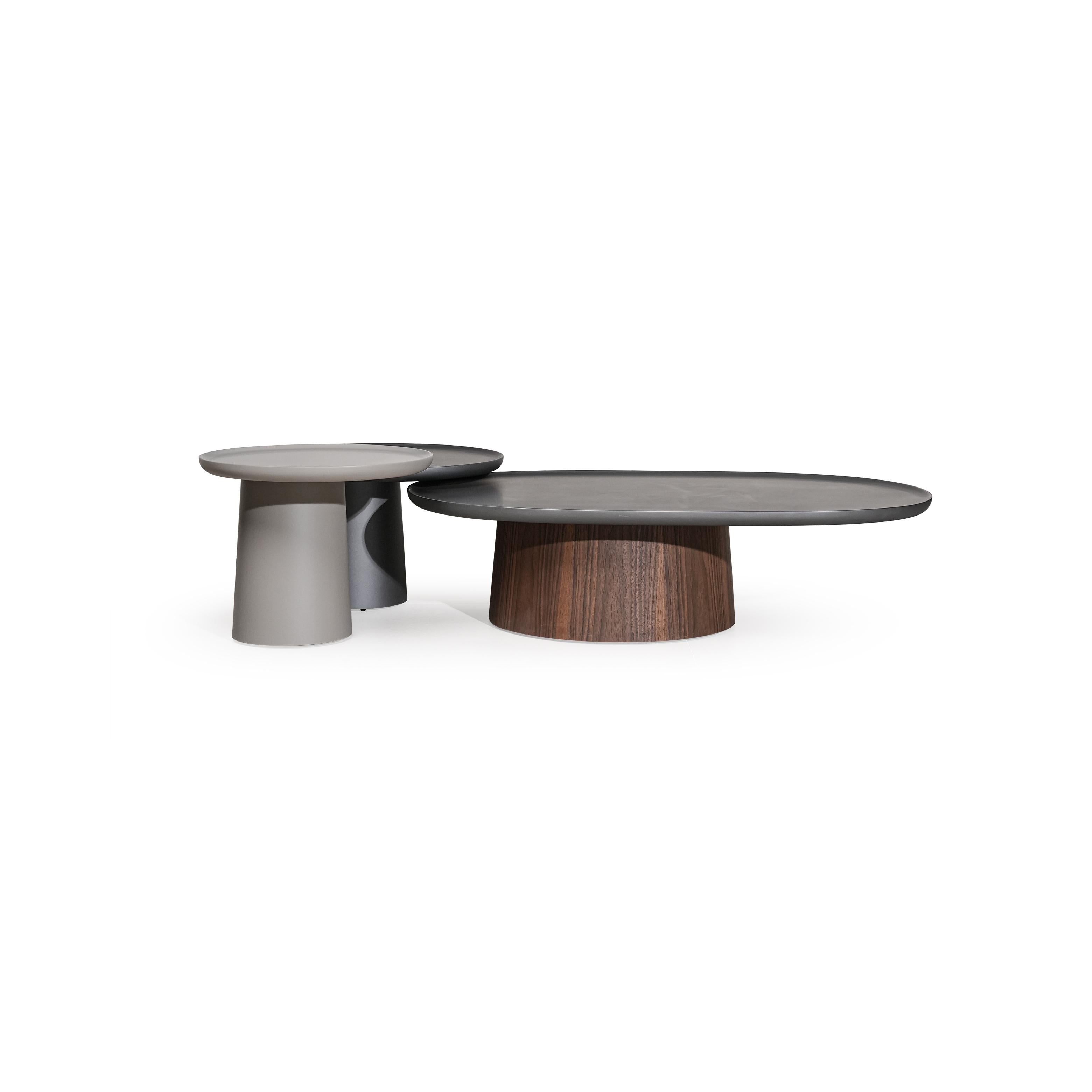 Round side table with a flat, dark gray top and a cylindrical pedestal base. No visible legs, handles, or drawers. Surface appears smooth and uniform. Intended for placing small items. Category: furniture/tables/side-tables