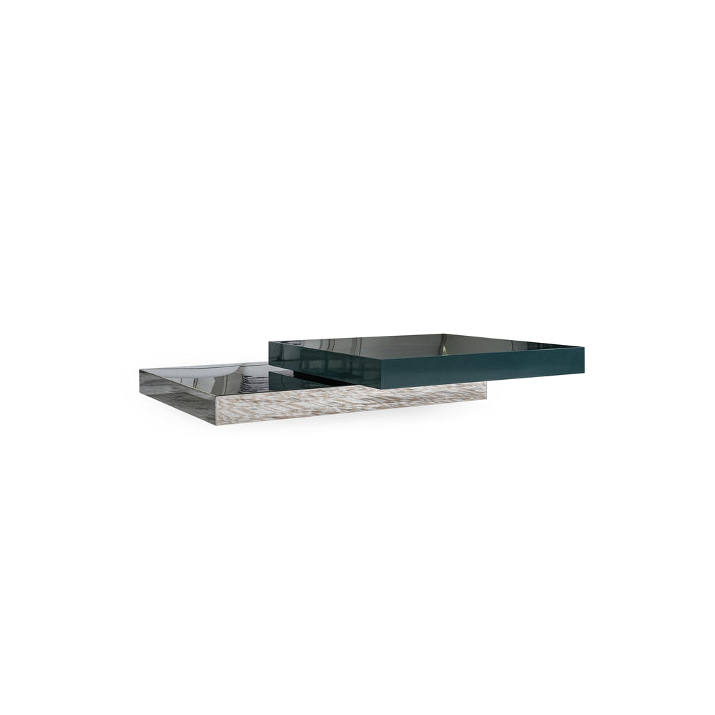 Modern rectangular coffee table with two tiers: lower tier has light wood-grain surface, upper tier is dark teal glossy finish. Features stacked, flat, rectangular surfaces with visible edges. Intended for placing items on a living room floor. Category: furniture/coffee-tables