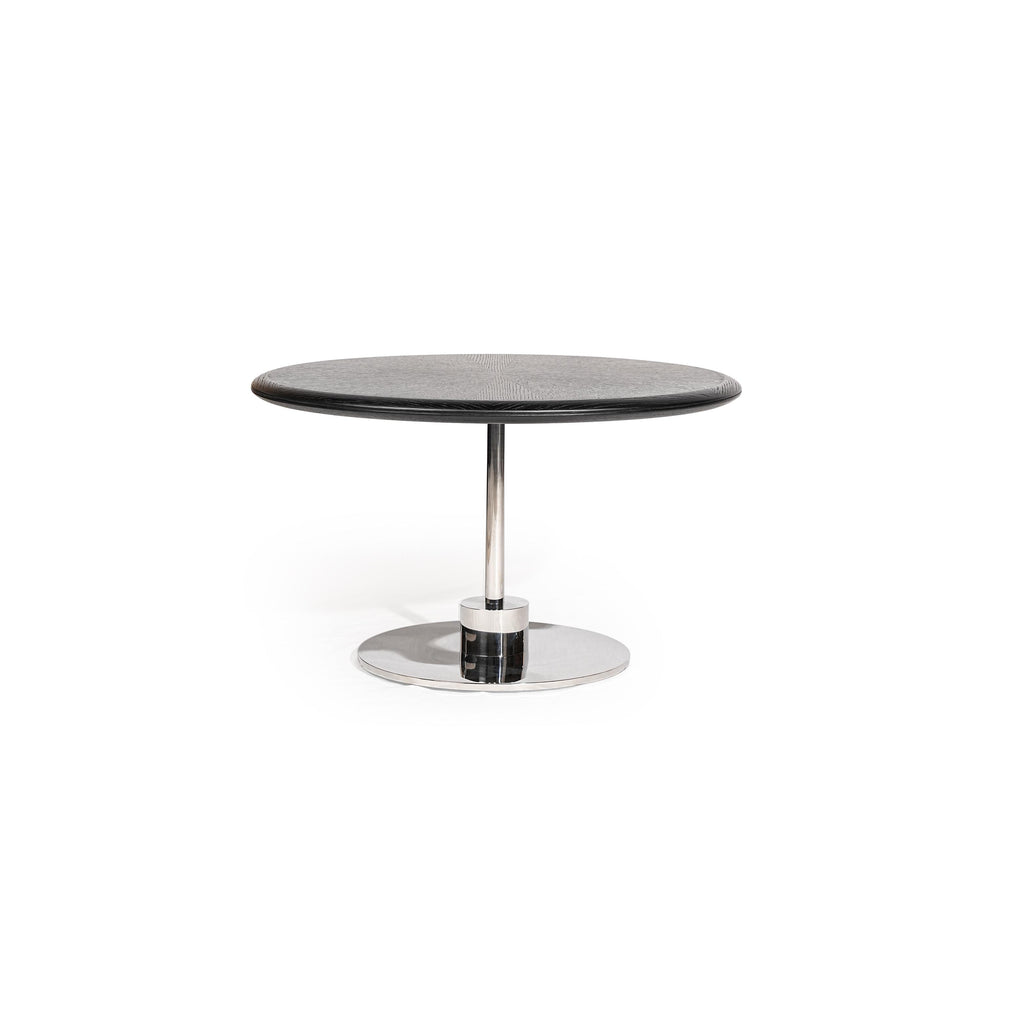 Round coffee table with dark gray textured top and polished chrome pedestal base. Single cylindrical leg connects to circular footplate. Sleek, minimalist design for seating areas. Category: furniture/coffee-tables