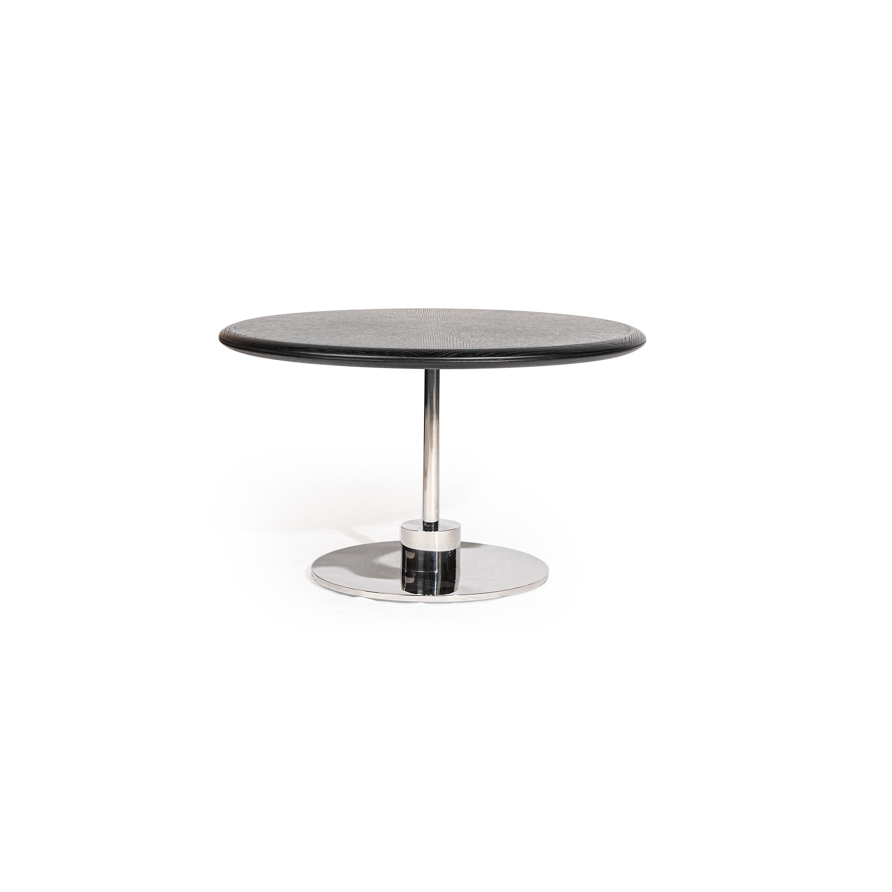 Round coffee table with dark gray textured top and polished chrome pedestal base. Single cylindrical leg connects to circular footplate. Sleek, minimalist design for seating areas. Category: furniture/coffee-tables