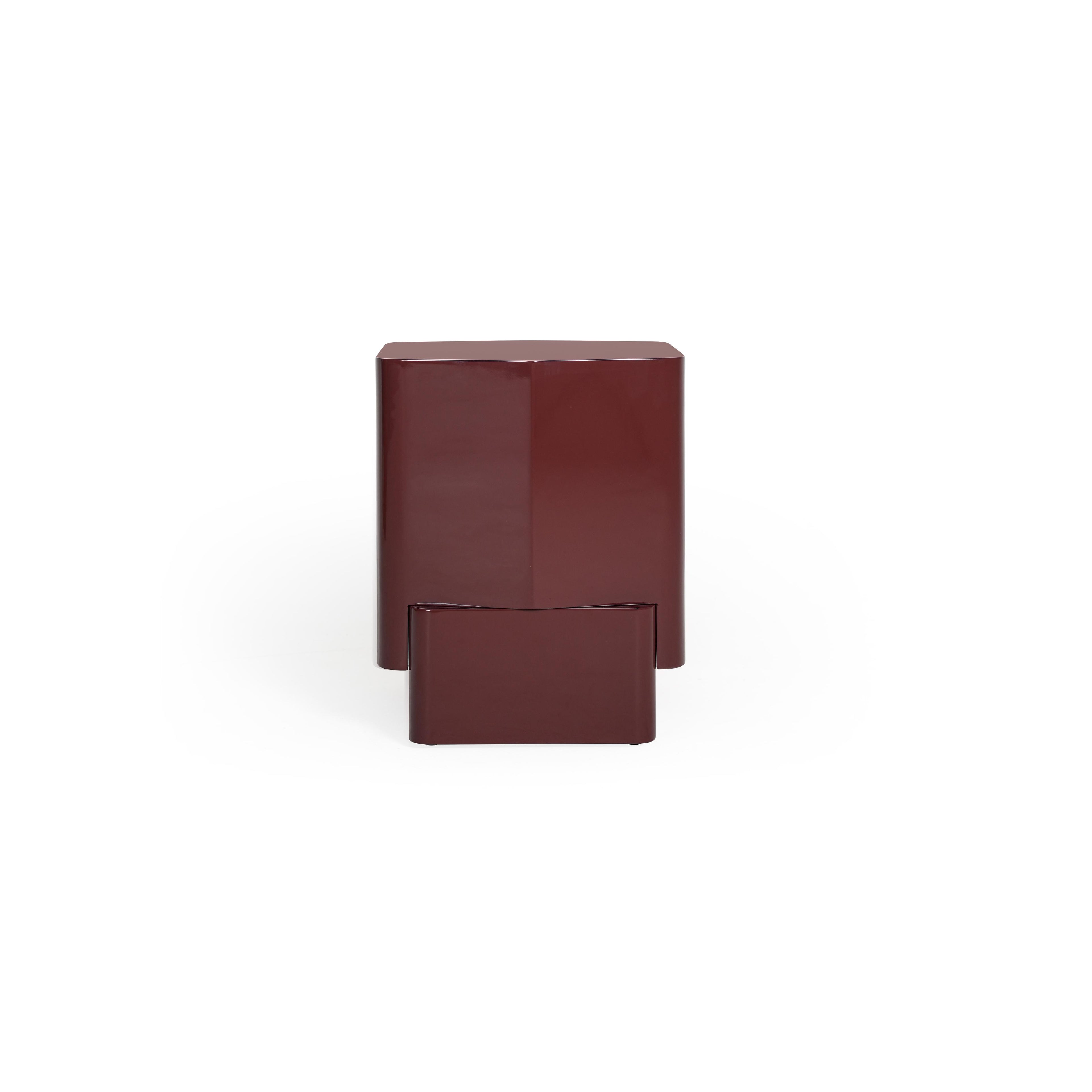 This is a modern side table with a two-tiered rectangular form in a glossy burgundy finish. It features a top shelf and a lower base, both with clean edges and no visible handles or fasteners. The surface appears smooth and uniform. Intended for placing items beside a sofa or bed. Category: Furniture > Tables > Side Tables