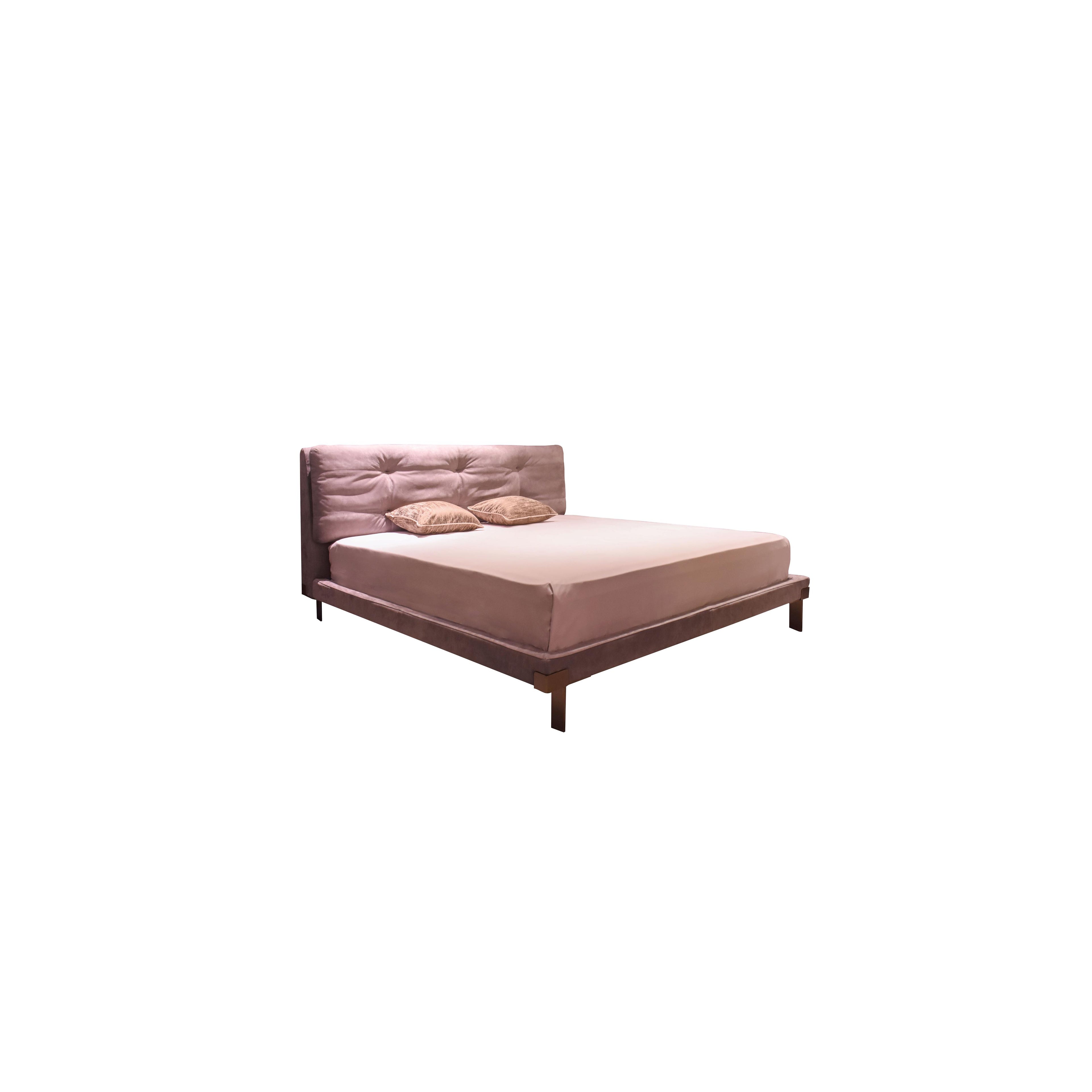 A upholstered bed with a tufted headboard and matching footboard, featuring a soft pink fabric surface, four dark wooden legs, and two pillows on the mattress. Designed for sleeping, it has a rectangular form with visible stitching and fabric texture. Category: Furniture > Beds > Upholstered Beds