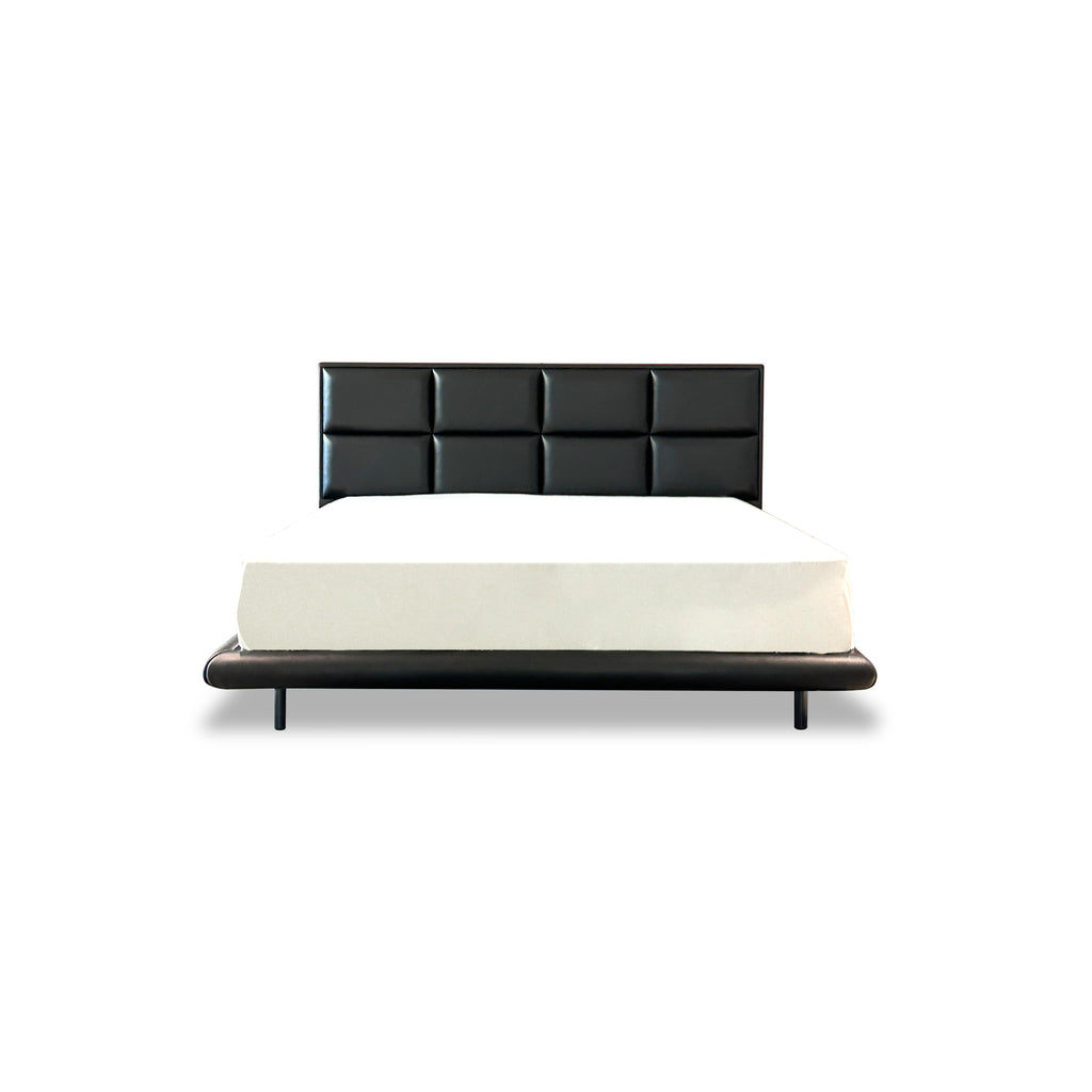 Black upholstered bed with tufted rectangular backrest and matching base frame, supported by four slender legs; white mattress rests atop; smooth, matte finish on all surfaces; designed for sleeping; Category: furniture > beds > upholstered beds