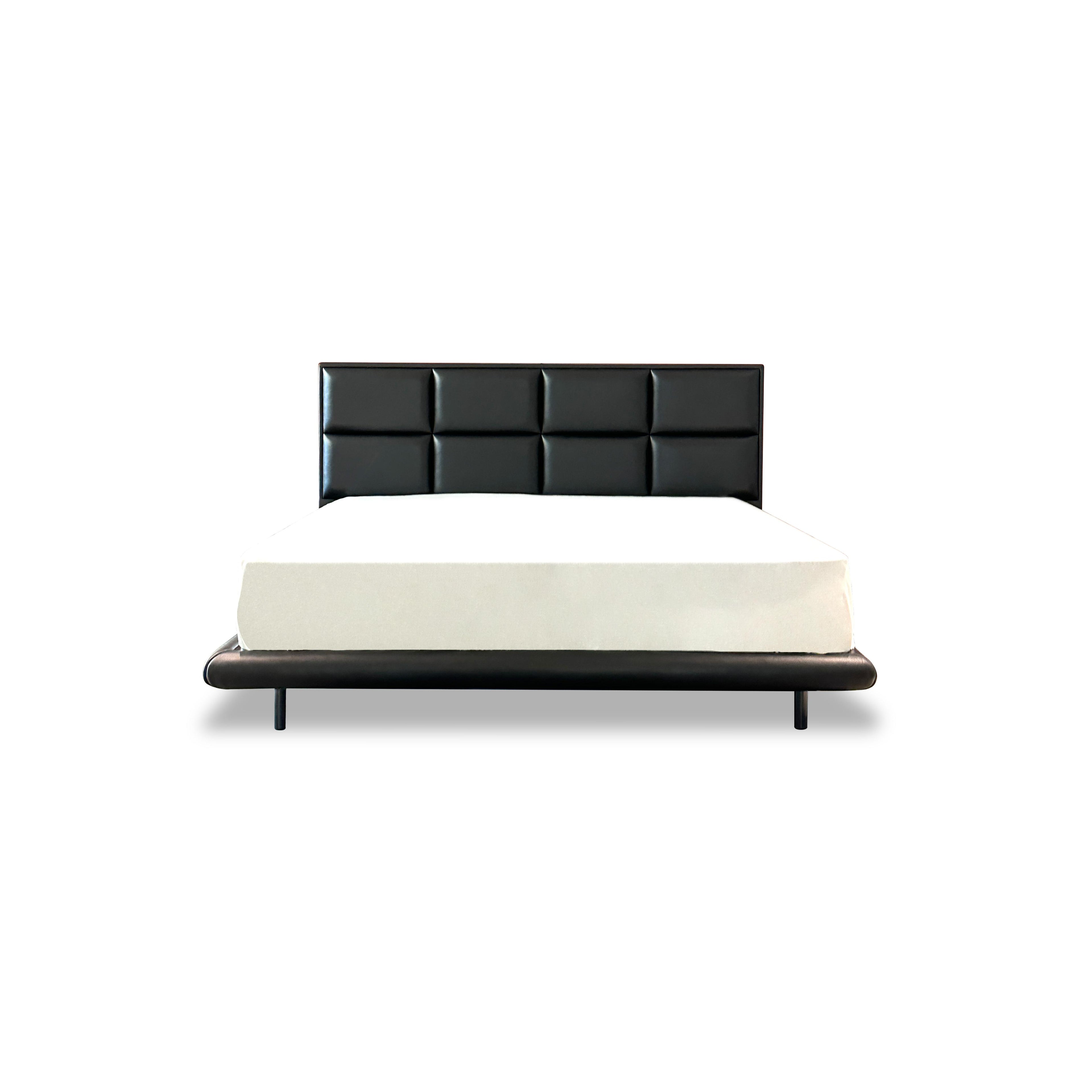 Black upholstered bed with tufted rectangular backrest and matching base frame, supported by four slender legs; white mattress rests atop; smooth, matte finish on all surfaces; designed for sleeping; Category: furniture > beds > upholstered beds