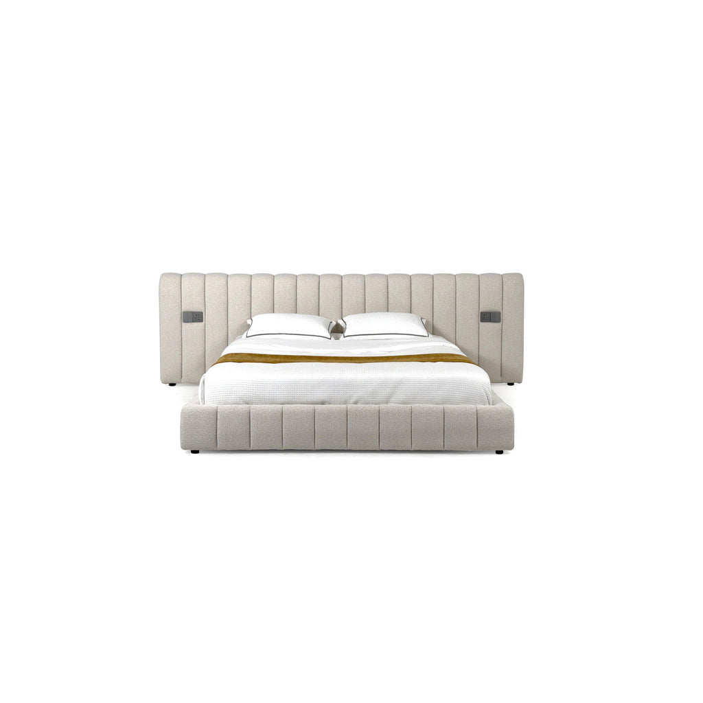 Tufted upholstered bed with a rectangular headboard and footboard, featuring vertical stitched panels, two white pillows, a white quilted mattress, and a mustard-colored throw. Black legs support the frame. Category: furniture > beds > upholstered beds