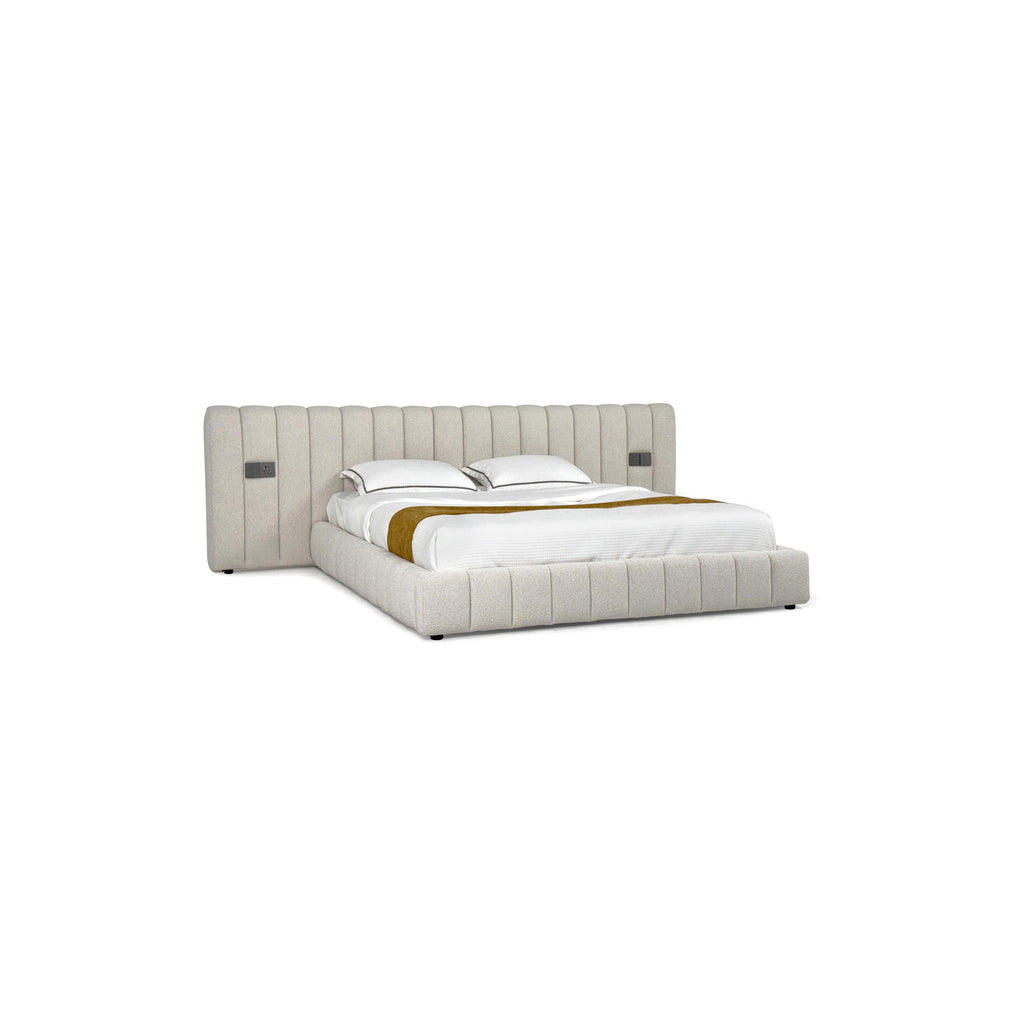 Tufted upholstered bed with a rectangular headboard and footboard, featuring vertical stitched panels, two white pillows, a white quilted mattress, and a mustard-colored throw. Black legs support the frame. Category: furniture > beds > upholstered beds