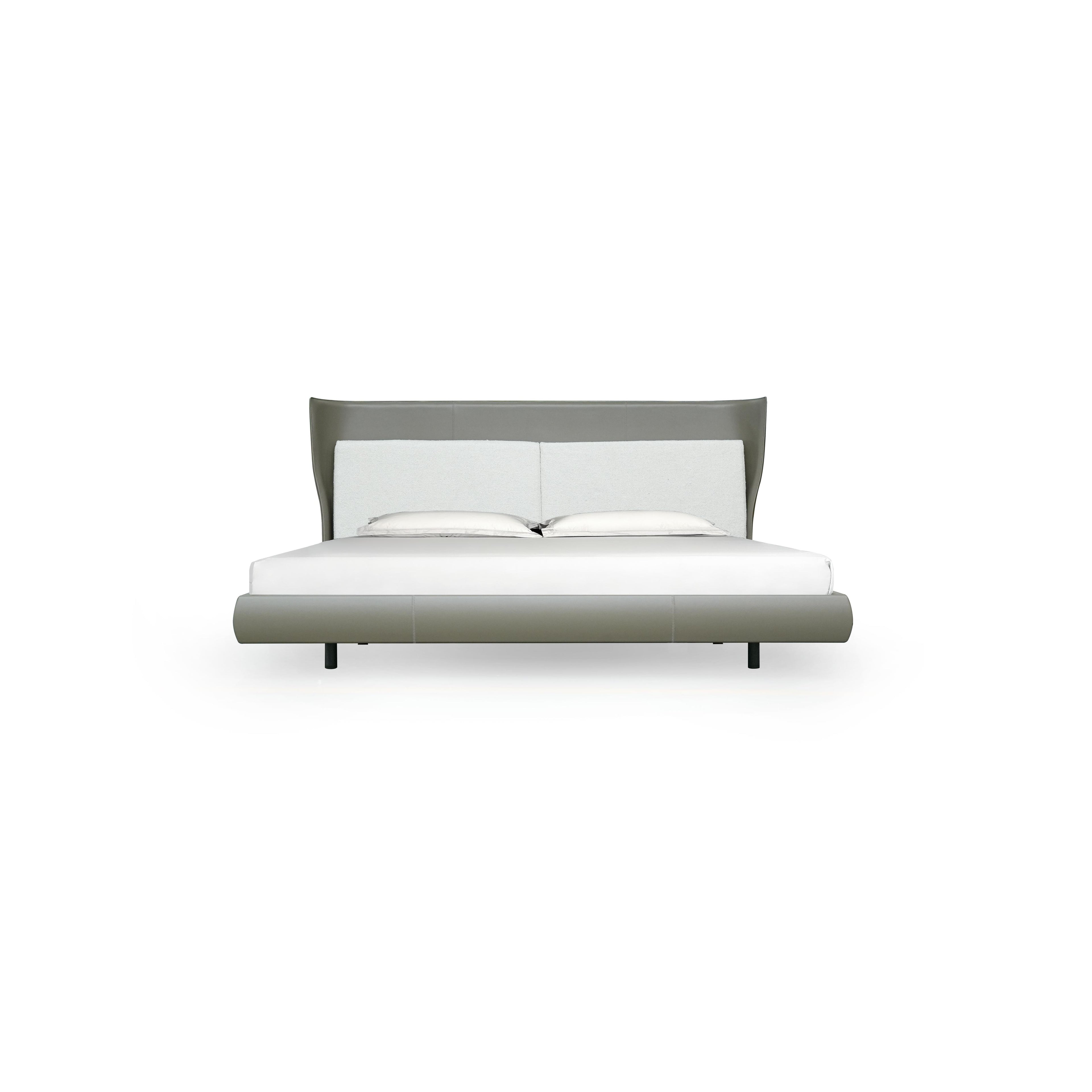 Modern bed with a low-profile frame and curved headboard, upholstered in light gray fabric with a subtle texture. It features two white pillows and a white mattress. Supported by four black legs, the bed has a sleek, minimalist silhouette. Category: furniture > beds > platform beds