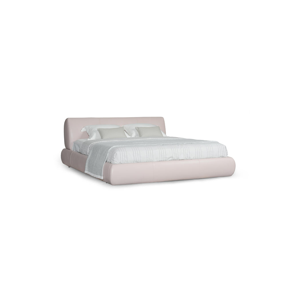 Low-profile platform bed with upholstered headboard and base in muted taupe fabric. Features padded cushions, subtle stitching, and short black legs. Designed for sleeping, with two white pillows and a light gray throw blanket. Category: furniture > beds > platform beds