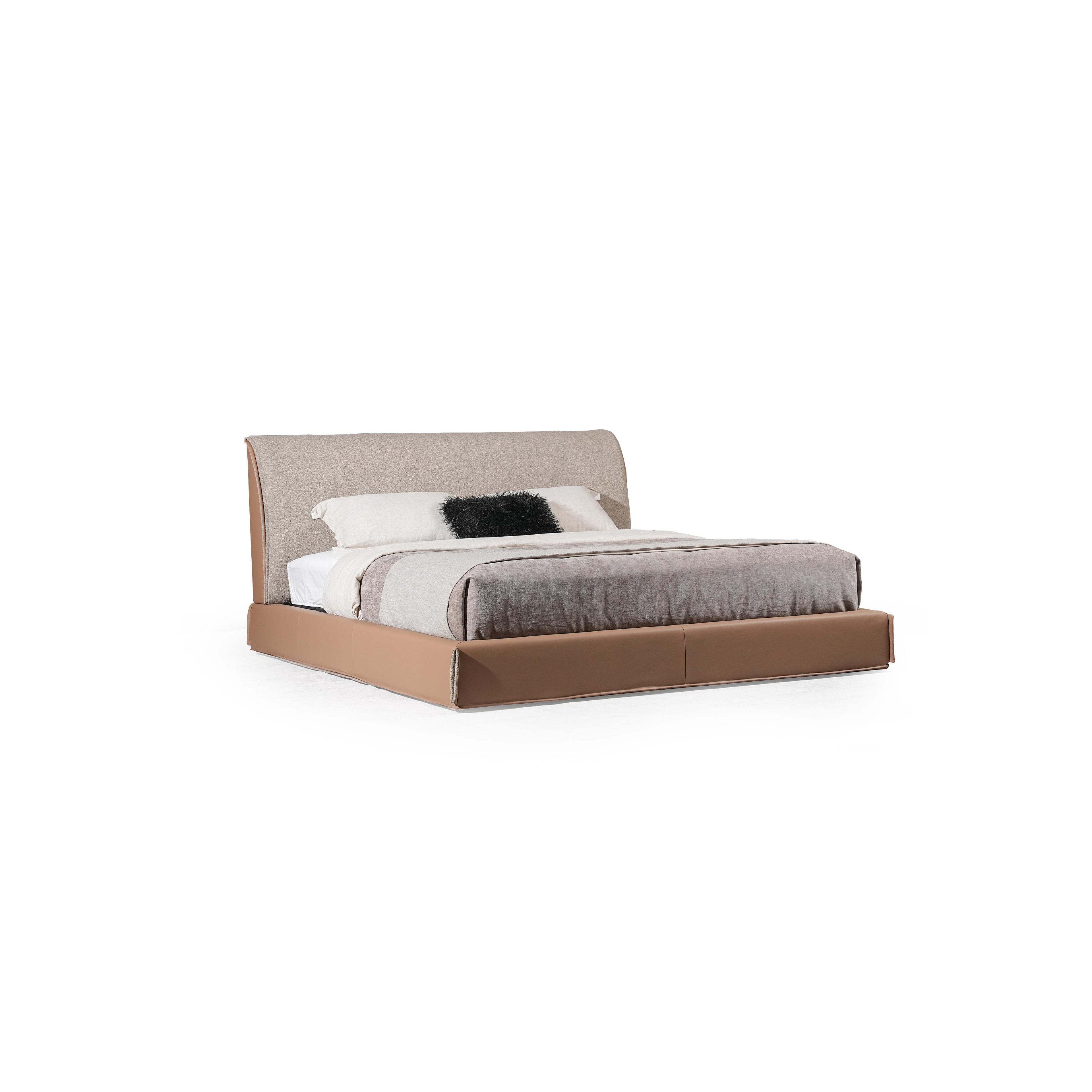 Low-profile bed with upholstered headboard and base, featuring beige fabric headboard, brown base, gray textured comforter, and white pillow with black furry accent; designed for sleeping, with clean lines and visible seam stitching. Category: furniture > beds > platform beds