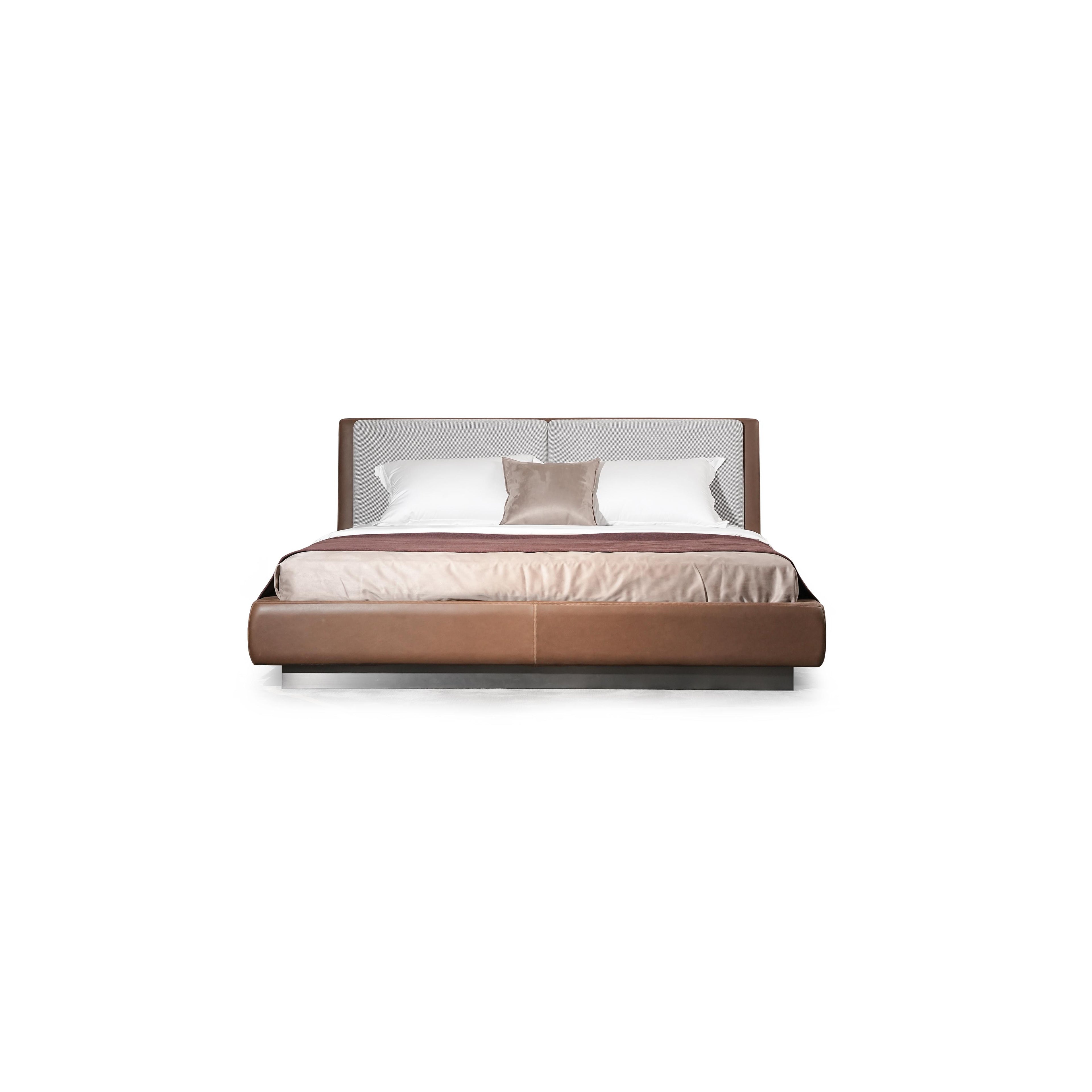 Modern platform bed with a two-tone upholstered headboard and base; brown leather-like material on sides and base, gray fabric on headboard; low-profile metal legs; white and beige bedding with a maroon throw; stitched seams visible; designed for sleeping; Category: Furniture > Beds > Platform Beds