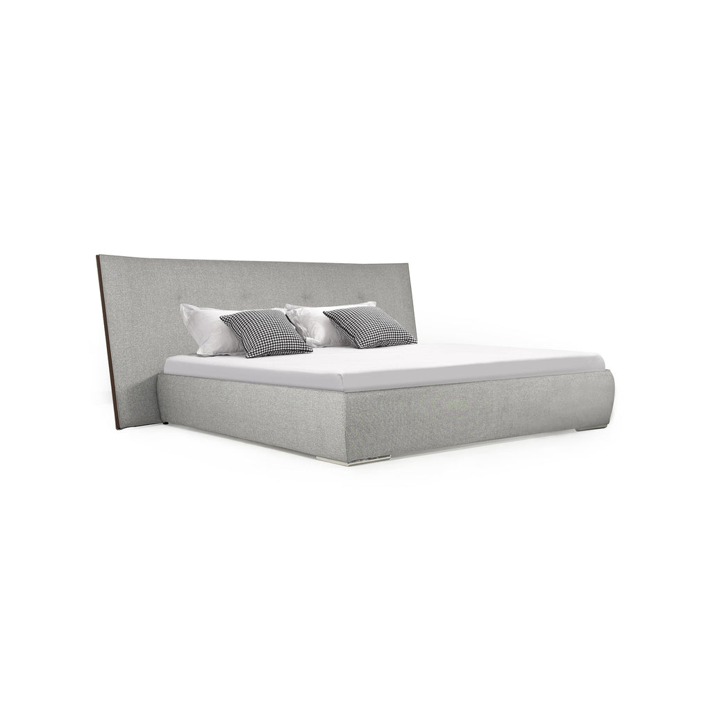 Upholstered bed with a rectangular headboard and footboard, both covered in gray textured fabric. It has a white mattress and two black-and-white checkered pillows flanked by white pillows. The bed has no visible legs or arms. Category: furniture > beds > upholstered beds