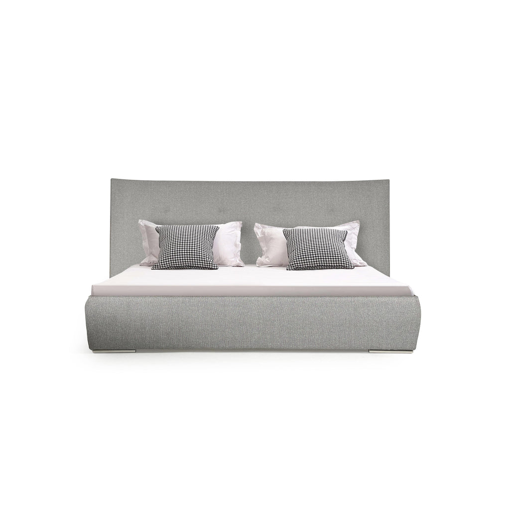 Upholstered bed with a rectangular headboard and footboard, both covered in gray textured fabric. It has a white mattress and two black-and-white checkered pillows flanked by white pillows. The bed has no visible legs or arms. Category: furniture > beds > upholstered beds