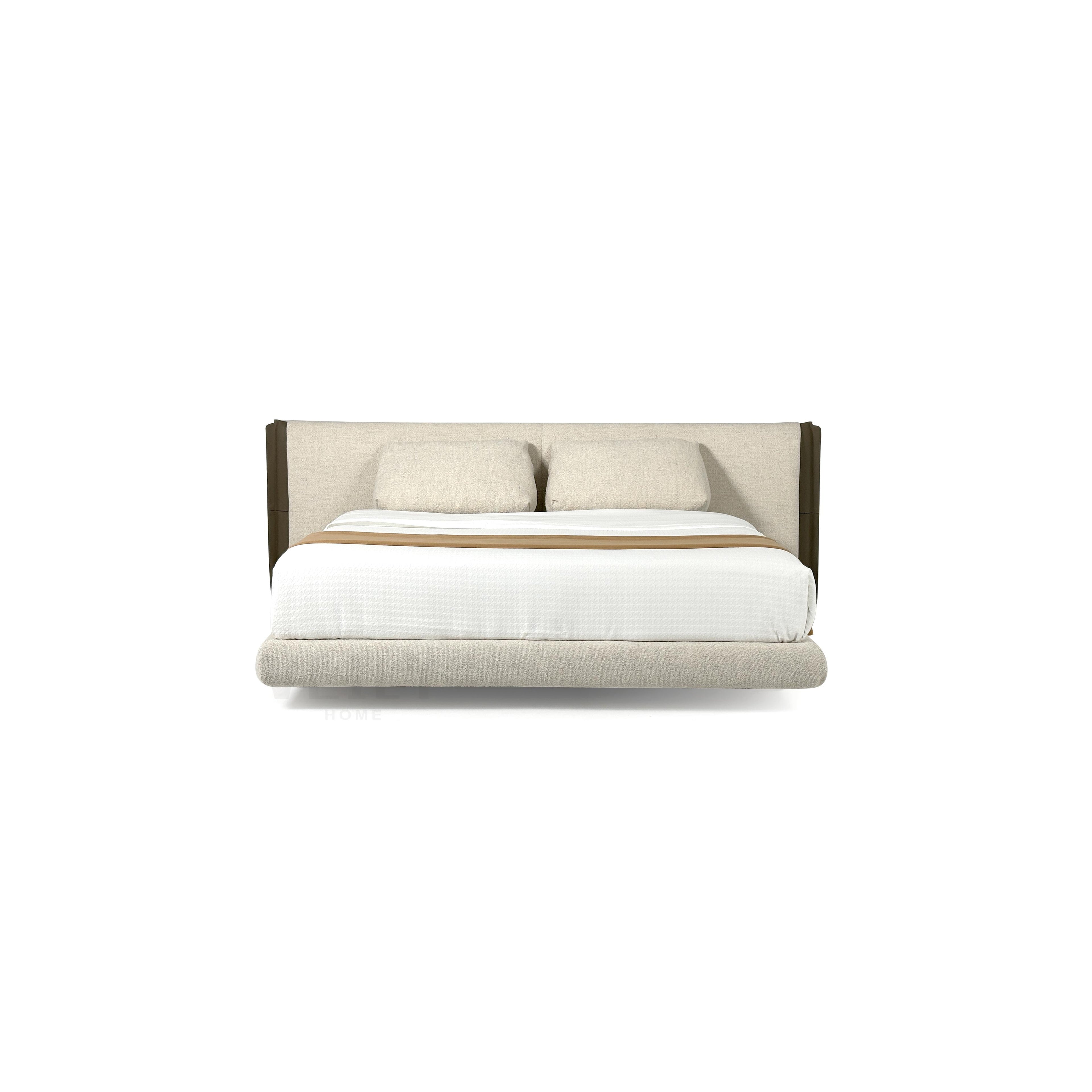 This is a upholstered bed with a low-profile frame and a padded headboard. It features two matching pillows, a white mattress cover, and a tan throw blanket. The headboard and base are covered in a textured fabric with dark brown vertical accents. The bed has four short, dark legs. Category: furniture > beds > upholstered beds