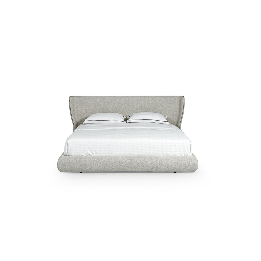 This upholstered bed features a low-profile frame with a padded headboard and base, covered in a light gray textured fabric. It includes two white pillows with dark trim and a white quilted mattress. Designed for sleeping, it has small black feet. Category: furniture > beds > upholstered beds