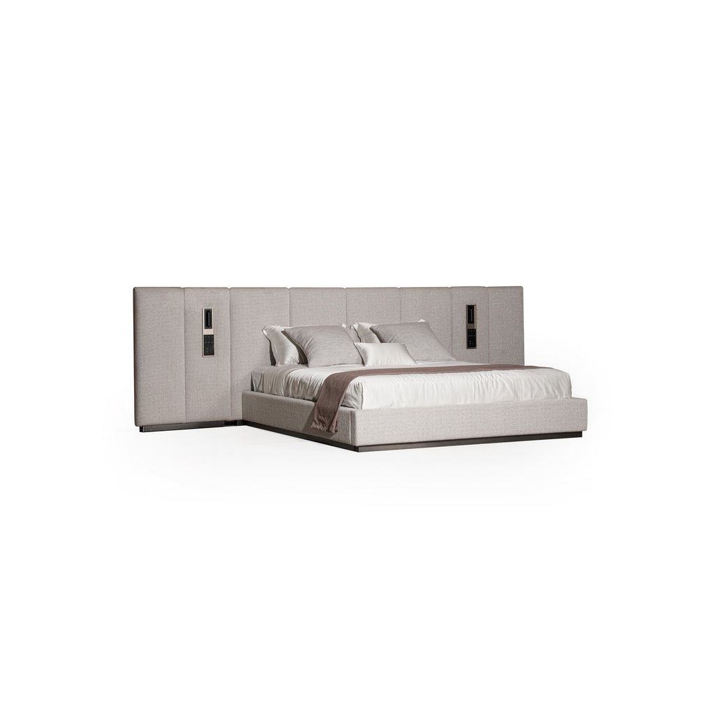 Upholstered bed with a rectangular headboard and matching footboard, featuring light gray fabric with subtle texture, two vertical panels on each side with recessed rectangular fixtures, and a white mattress with pillows; intended for sleeping; Category: furniture > beds > upholstered beds