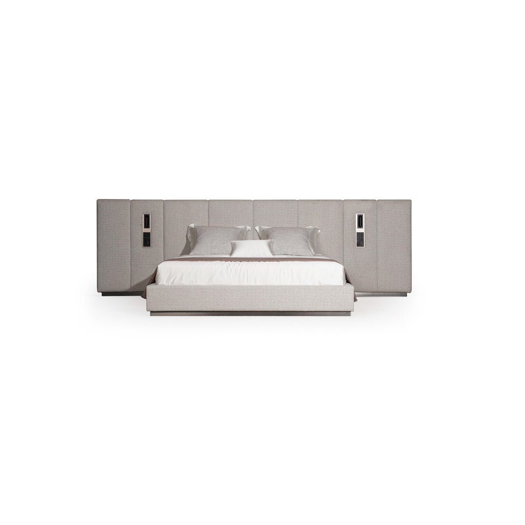 Upholstered bed with a rectangular headboard and matching footboard, featuring light gray fabric with subtle texture, two vertical panels on each side with recessed rectangular fixtures, and a white mattress with pillows; intended for sleeping; Category: furniture > beds > upholstered beds