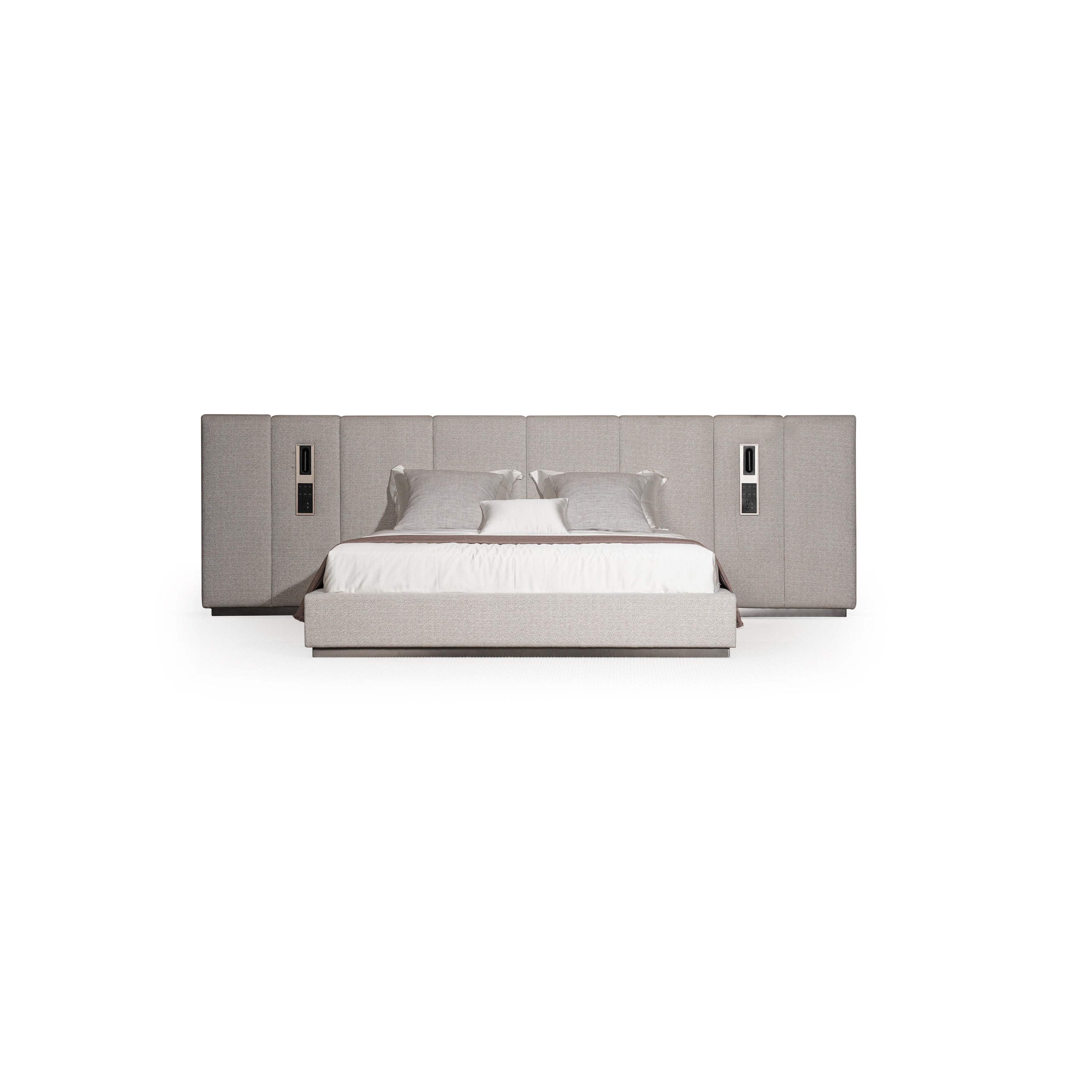 Upholstered bed with a rectangular headboard and matching footboard, featuring light gray fabric with subtle texture, two vertical panels on each side with recessed rectangular fixtures, and a white mattress with pillows; intended for sleeping; Category: furniture > beds > upholstered beds