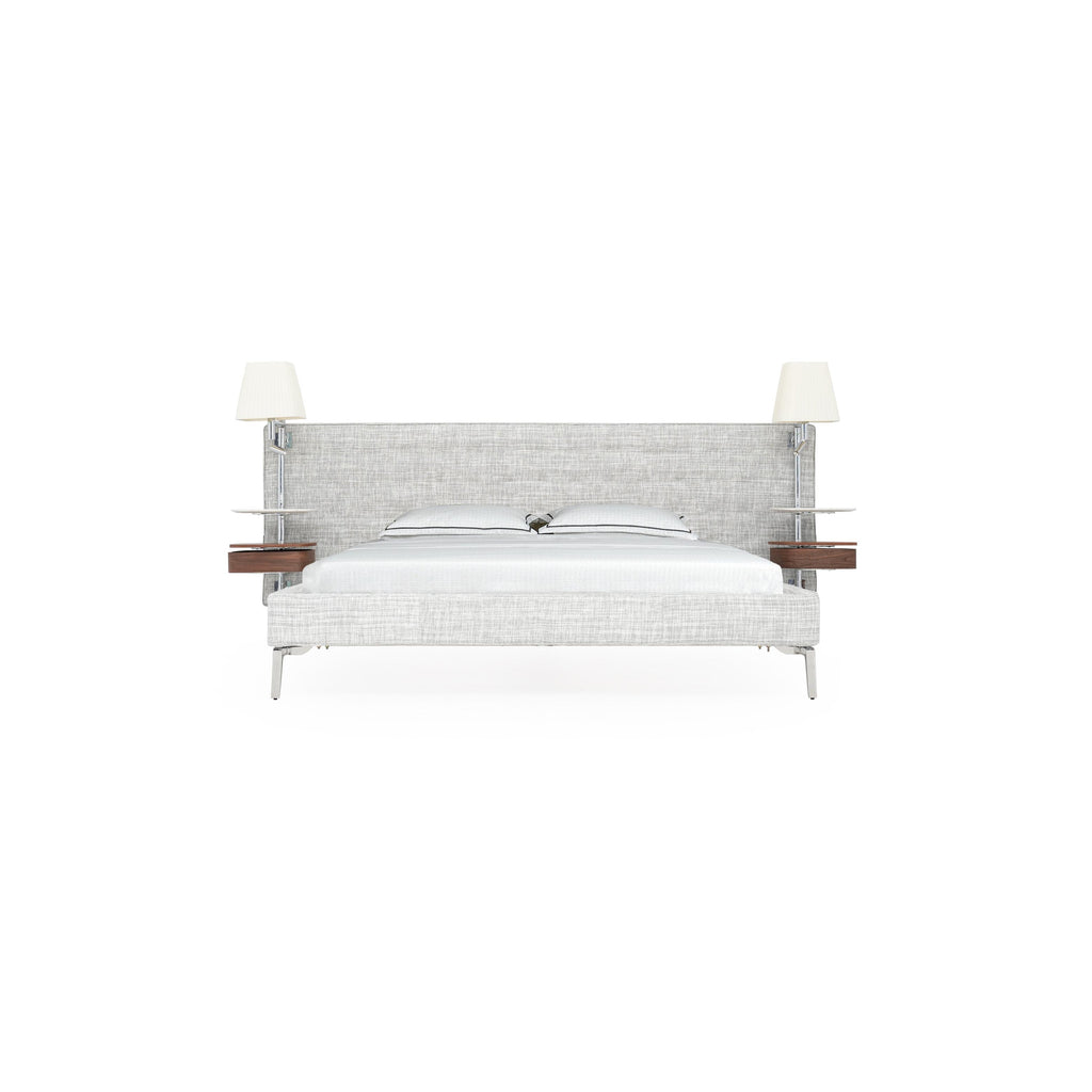 Modern upholstered bed with light gray textured fabric, metal legs, and integrated headboard with two wall-mounted lamps and wooden shelves. Features two pillows and white bedding. Intended for sleeping. Category: furniture > beds > upholstered beds