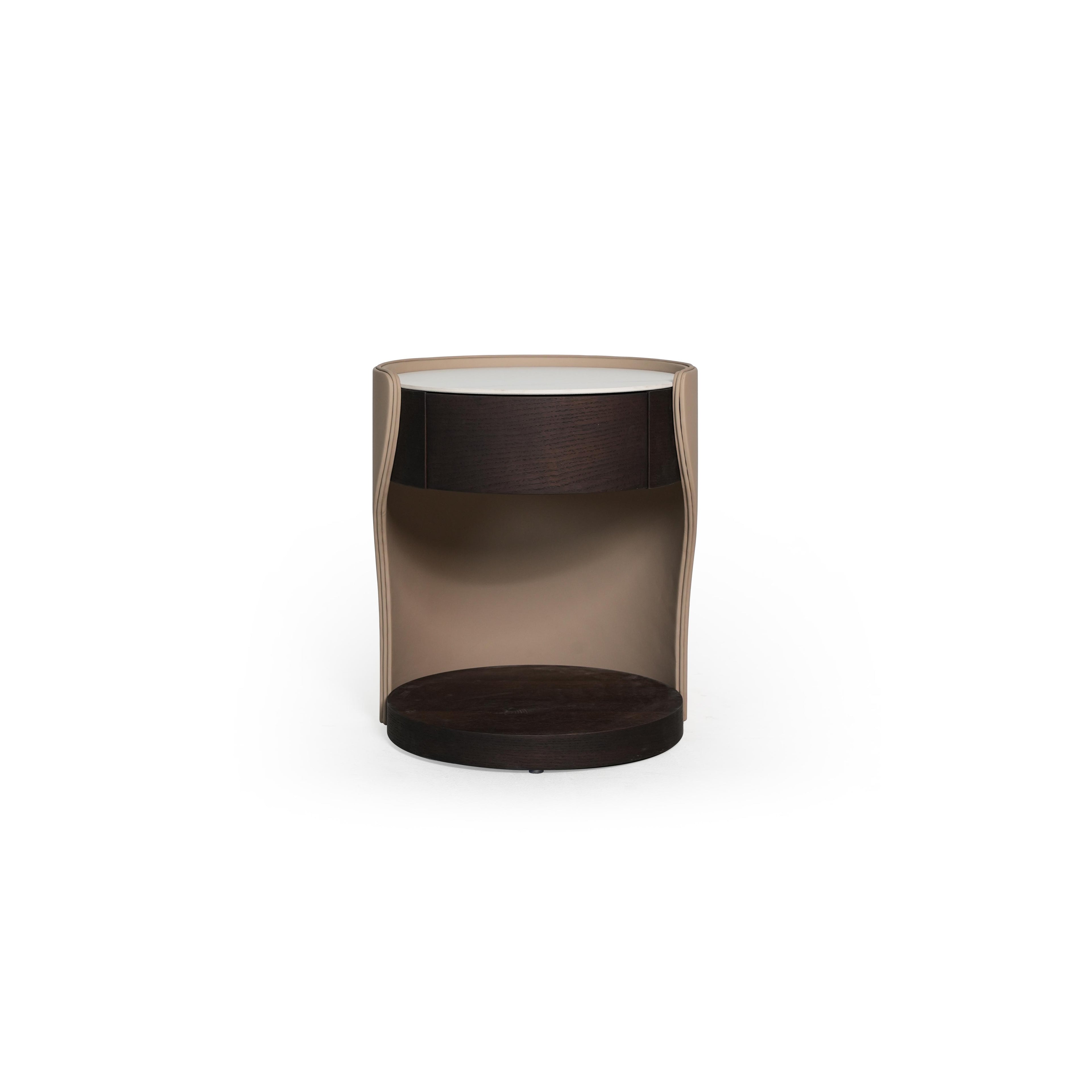 Round side table with a white top, dark wood drawer front, and a curved beige frame. Features a dark wood base and open interior. Designed for bedside or accent placement. Category: furniture/side-tables