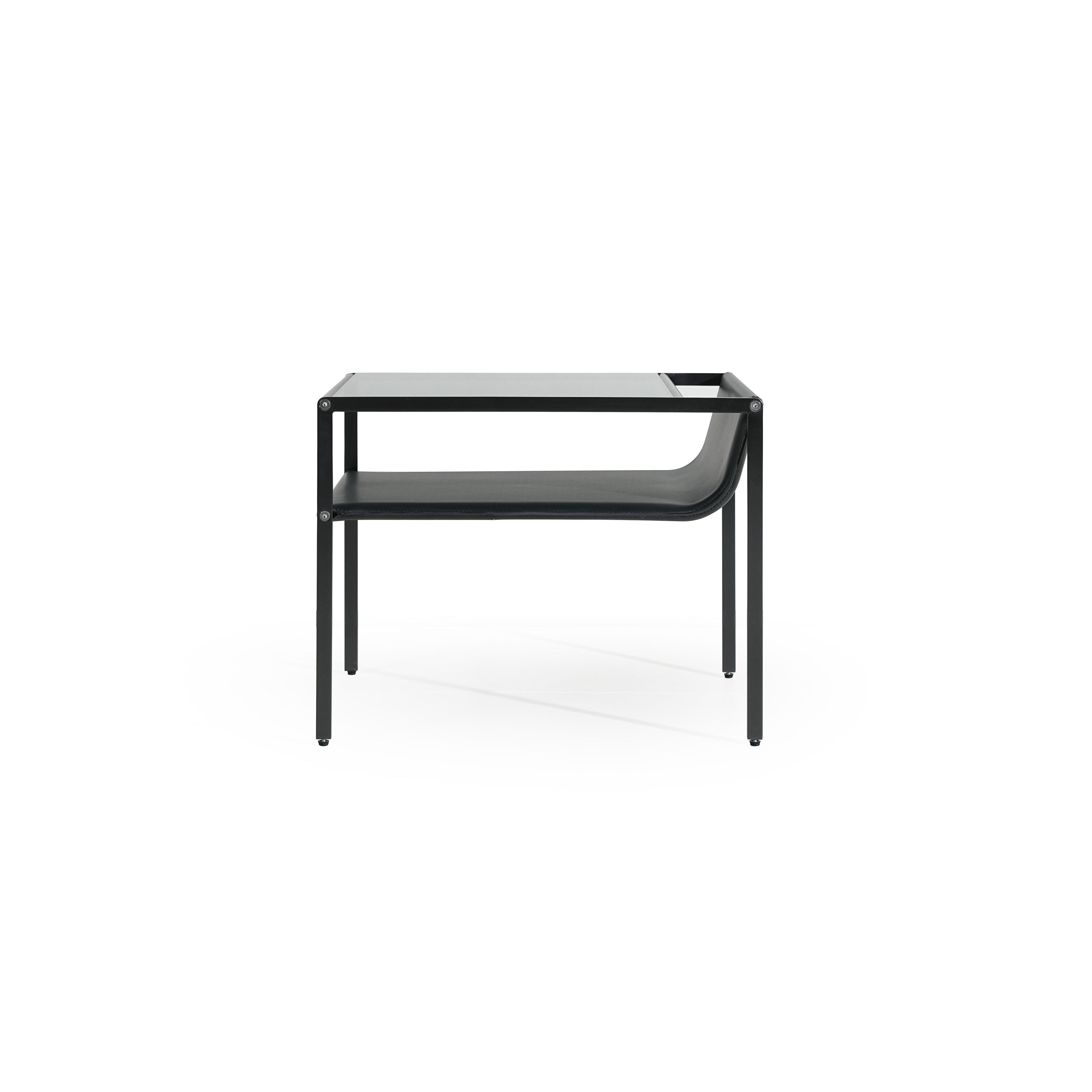 Black metal-framed side table with glass top and lower shelf, featuring curved leather-like surface on the shelf. Four straight legs support the structure. Designed for holding items or as a decorative piece. Category: furniture/side-tables