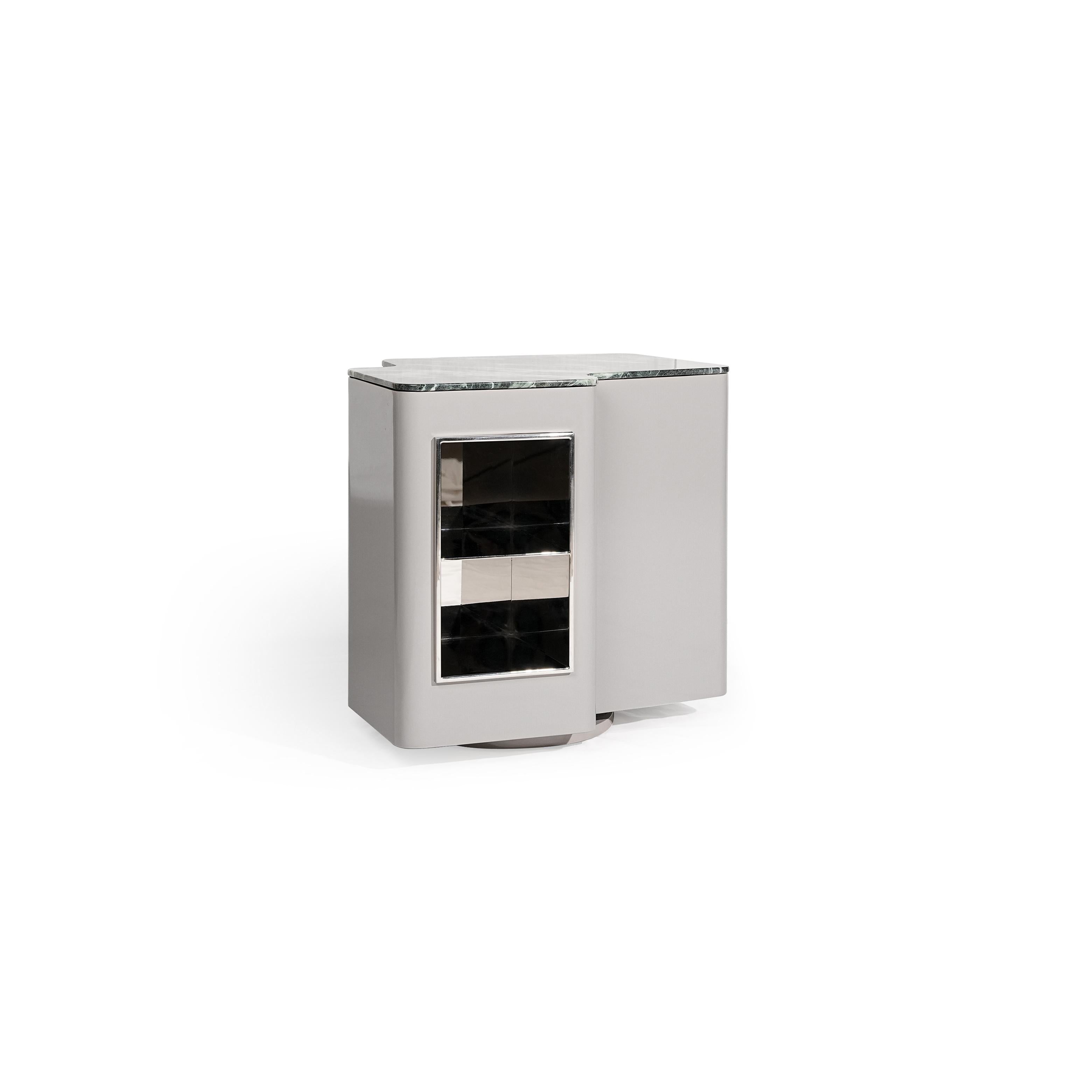 Modern side table with a rectangular form, featuring a gray marble top, a silver-finished frame, and a glass-fronted compartment with two horizontal shelves. It has a single visible door and a circular base. Intended for holding small items or as a decorative accent. Category: Furniture > Tables > Side Tables