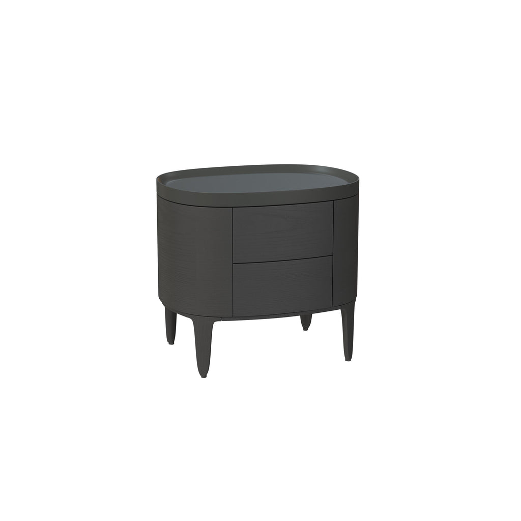 This is a side table with a rounded top and curved body, featuring two drawers and four tapered legs. It has a dark gray finish with subtle wood grain texture. Intended for bedside or accent placement, it includes no visible handles or fasteners. Category: furniture > tables > side tables