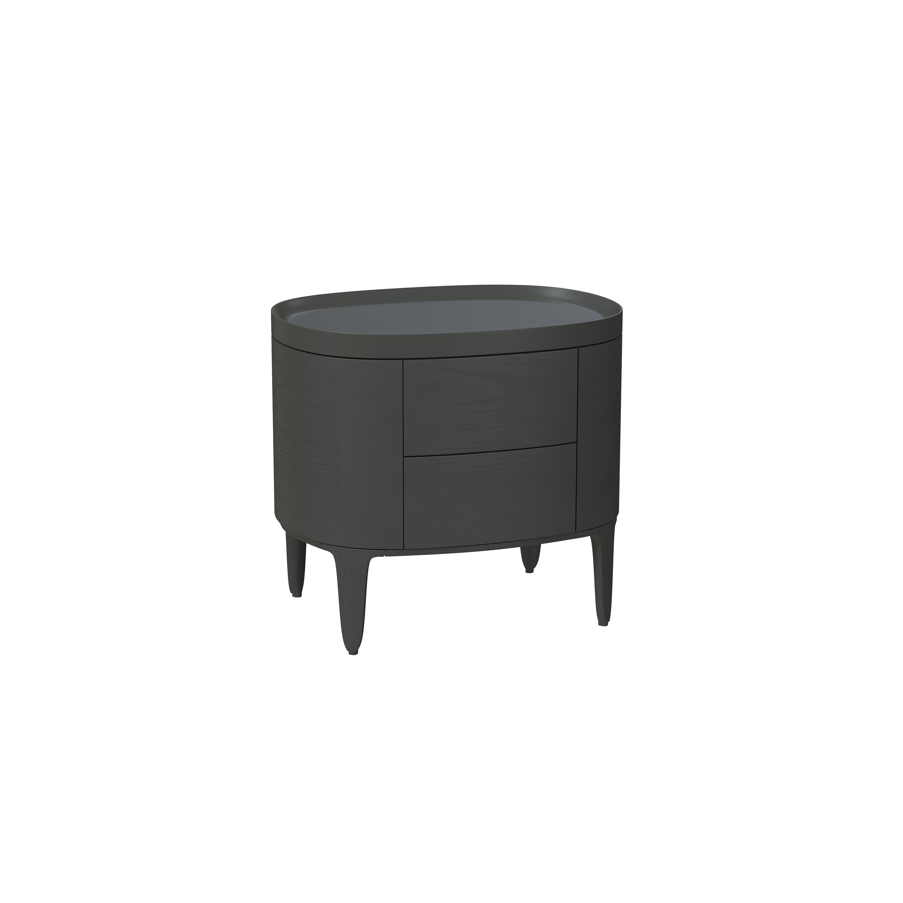 This is a side table with a rounded top and curved body, featuring two drawers and four tapered legs. It has a dark gray finish with subtle wood grain texture. Intended for bedside or accent placement, it includes no visible handles or fasteners. Category: furniture > tables > side tables