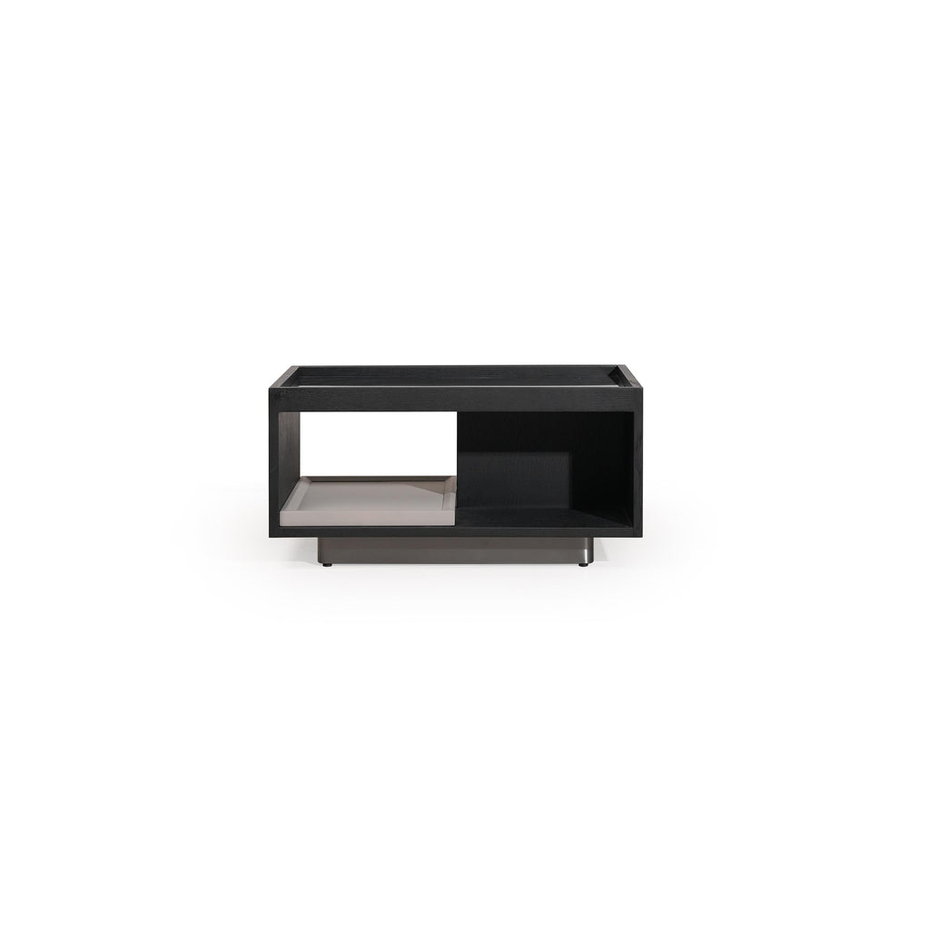 Black rectangular side table with open shelf and recessed compartment, supported by a cross-shaped base; matte finish, no visible texture or fabric; designed for holding items or displaying objects; Category: furniture/side-tables