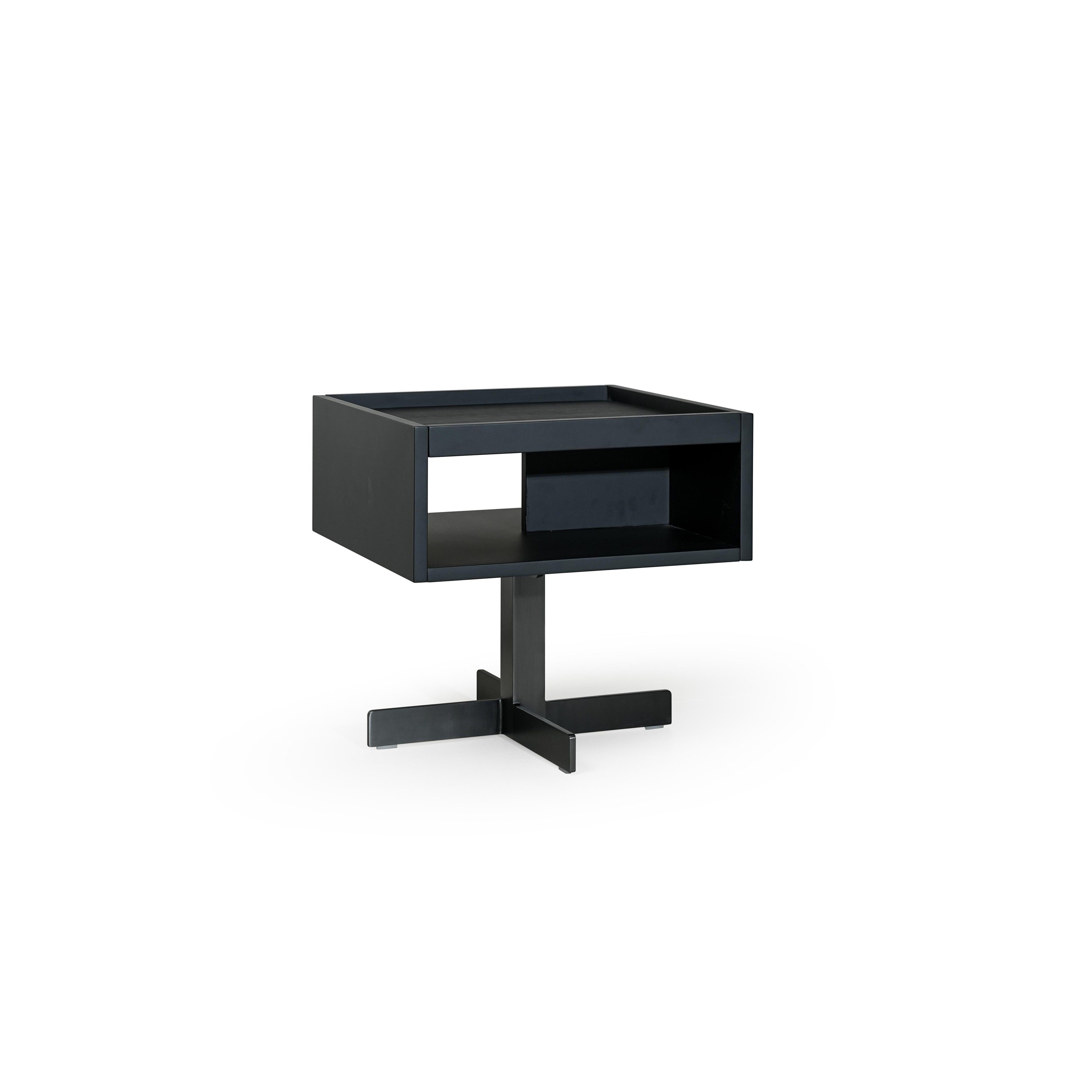 Black rectangular side table with open shelf and recessed compartment, supported by a cross-shaped base; matte finish, no visible texture or fabric; designed for holding items or displaying objects; Category: furniture/side-tables